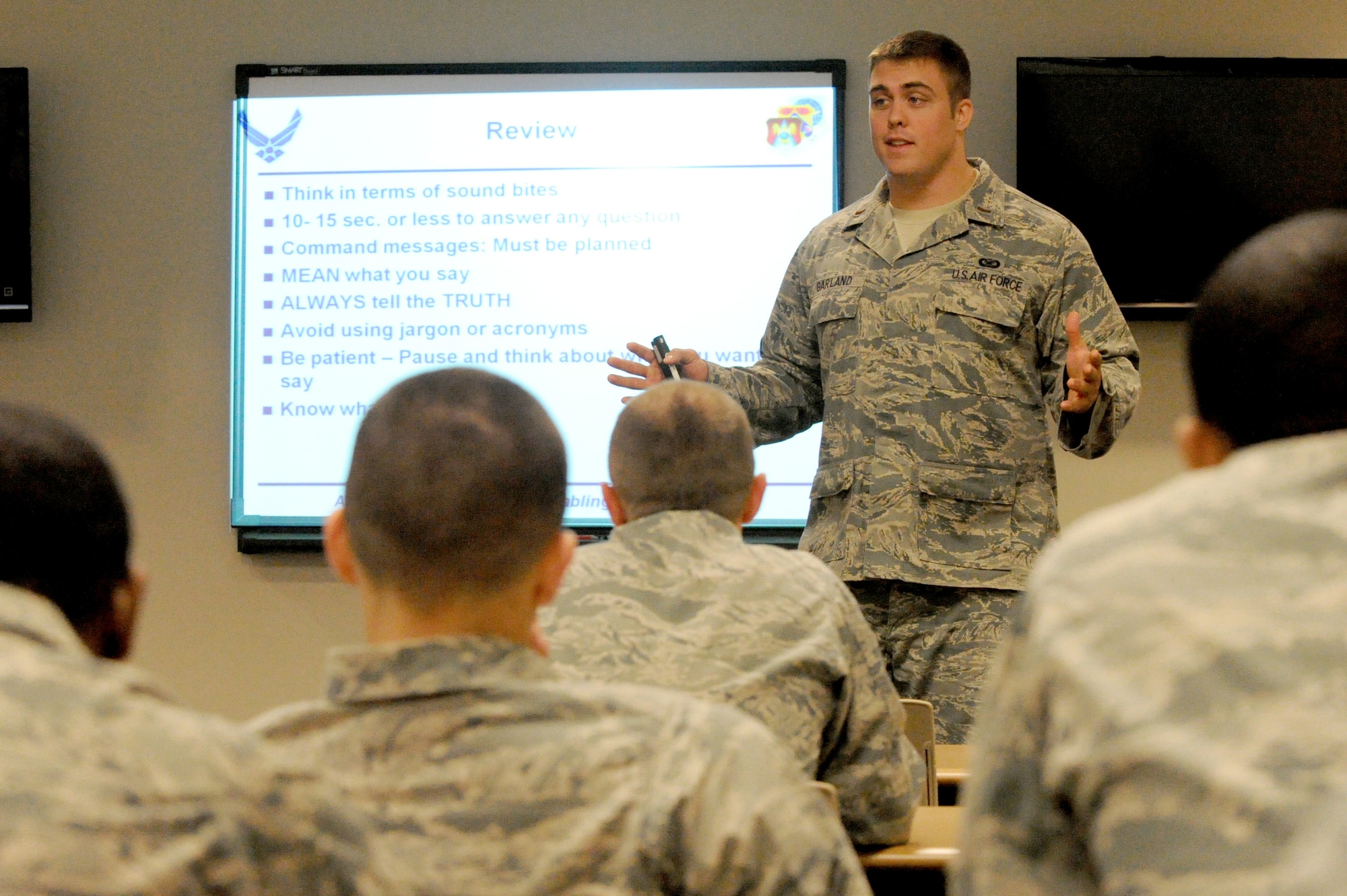 Second Lt. Ben Garland, 375th Air Mobility Wing Public Affairs chief of media operations, trains Security Forces Airmen on how to deal with media during crisis response events April 11, 2012 at Scott Air Force Base, Ill. Garland has been released from active duty through the Palace Chase program and is currently attending Denver Broncos conditioning and tryout camps. (U.S. Air Force photo/ Staff Sgt. Brian J. Valencia)
