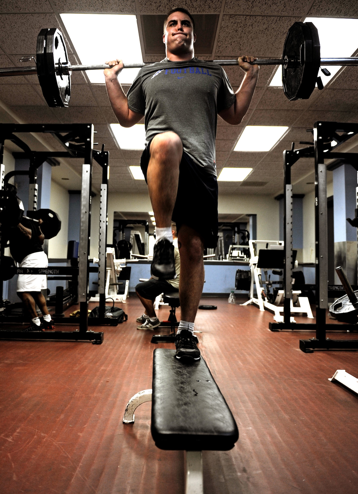 Second Lt. Ben Garland, 375th Air Mobility Wing Public Affairs chief of media operations, performs one-leg step ups during his workout March 12, 2012 at the James Gym on Scott Air Force Base, Ill. Garland received workout routines from the Denver Broncos that he combined with a healthy diet to help keep himself mentally and physically ready for his shot with the Denver Broncos. (U.S. Air Force photo/Staff Sgt. Brian J. Valencia)