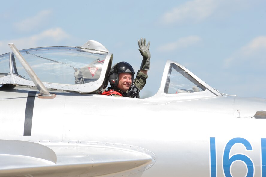Randy Ball, MiG-17F pilot, greets the crowd after his performance at the 2012 Barksdale Air Force Base Defenders of Liberty Air Show, April 22. The aircraft's agility, power and speed influenced its long use by the Soviet Union from its introduction in the early 1960s until it was pulled from service in 1990. (U.S. Air Force photo/Airman 1st Class Andrew Moua)(RELEASED)
