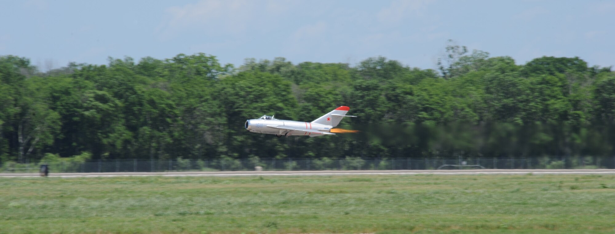 Randy Ball, MiG-17F pilot, activates his afterburners during takeoff at the 2012 Barksdale Air Force Base Defenders of Liberty Air Show, April 22. Ball is an aerial stunt performer, and an airline captain with more than 20 years of flying experience. (U.S. 1st Force photo by Airman First Class Andrew Moua)(RELEASED)