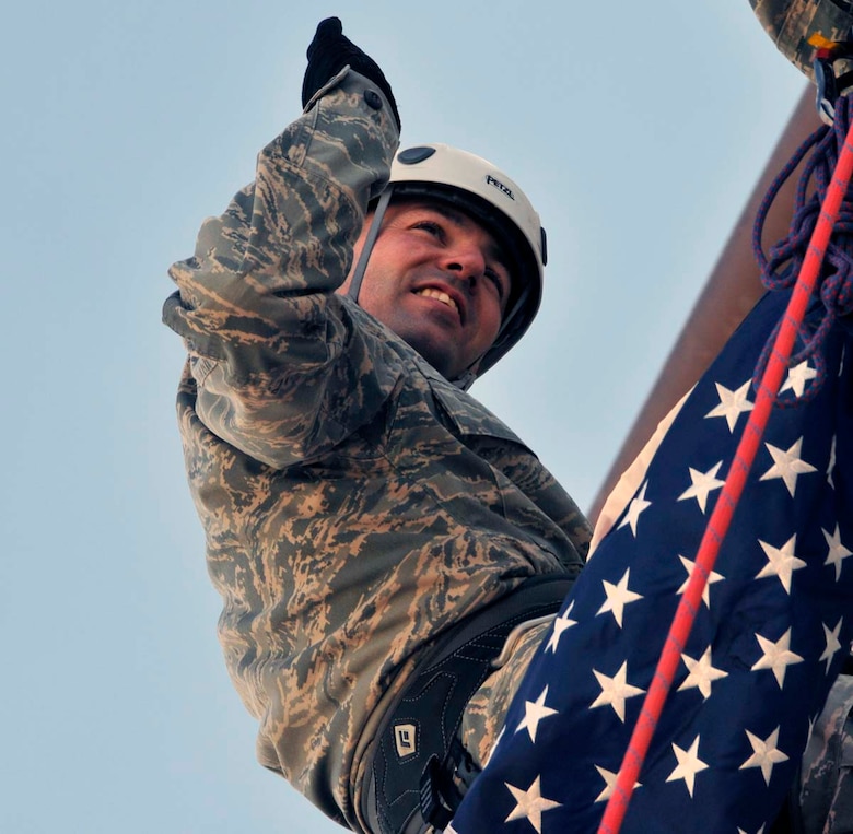 Master Sgt. Curtis Wilson takes the oath of reenlistment from his brother Capt. Heath Wilson while rapelling from a wall at the U.S. Air Force Pararescue School at Kirtland Air Force Base, N.M., April 2012. Sergeant Wilson is assigned to Air Force Operational Test and Evaluation Headquarters at Kirtland. The Wilson family has more than 300 years of military service spanning three generations.  (Photo by George Diamond).