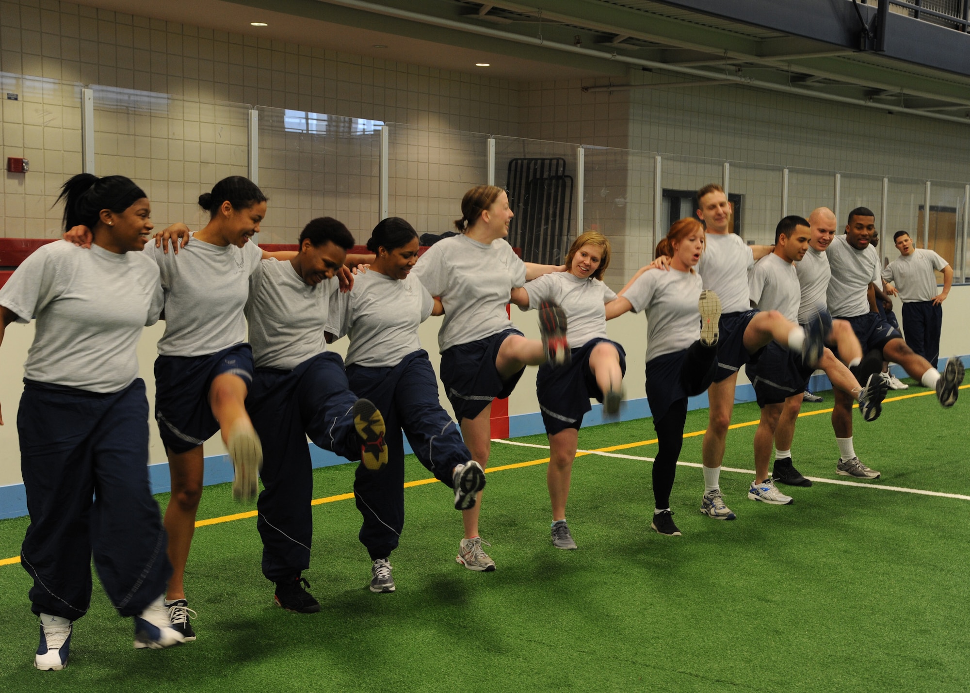 Members of the 319th Logistics Readiness Squadron break out into a "flash mob" dance session to surprise their commander, Maj. Rey Gonzalez, during an April 17, 2012, physical training session in the field house on Grand Forks Air Force, Base, N.D. (U.S. Air Force photo/Senior Airman Amber Bennett)