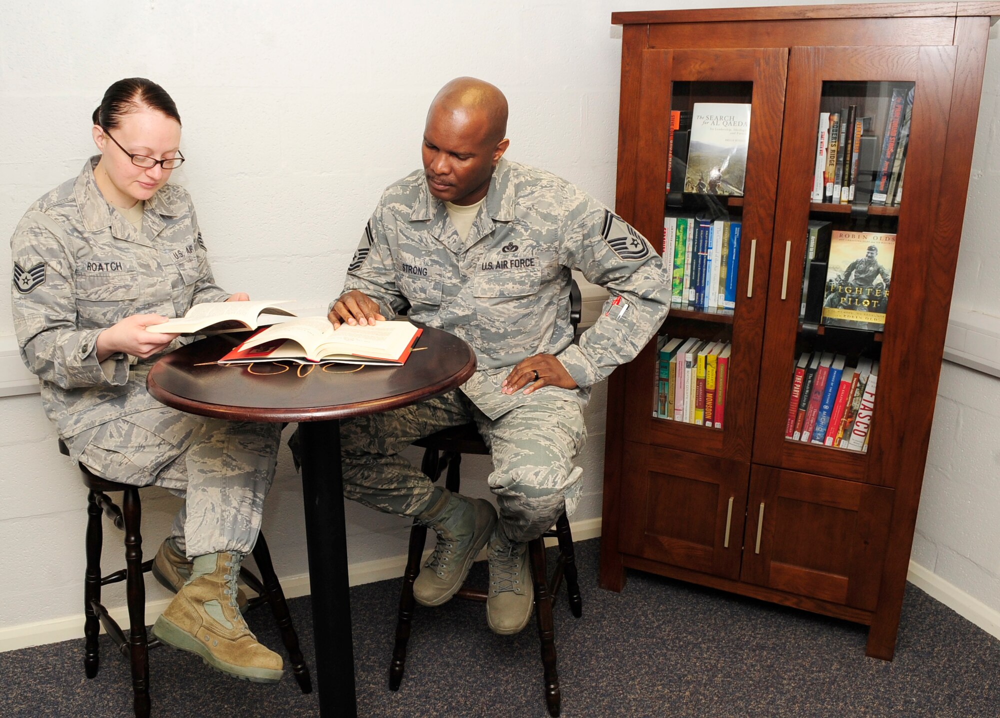 RAF MILDENHALL, England -- Staff Sgt. Justine Roach and Master Sgt. Frank Strong, both 352nd Special Operations Group, browse through books in the newly opened 352nd SOG Heritage Library April 23, 2012. The library was officially opened April 17 by Col. Gary McCollum, 352nd SOG commander, Chief Master Sgt. Paul Henderson, 352nd SOG command chief, and Patrick Charles, 352nd SOG historian. (U.S. Air Force photo/Senior Airman Ethan Morgan)