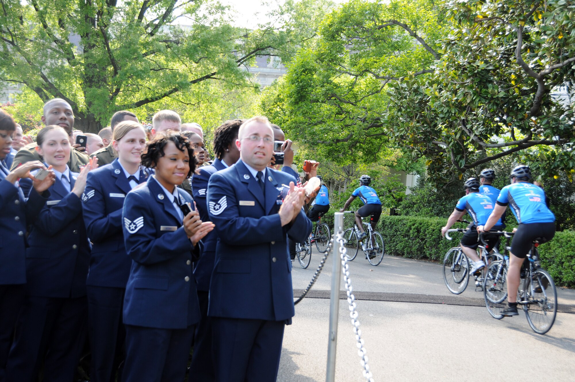 Members from the 459th Air Refueling Wing at Joint Base Andrews, Md., cheer on wounded warriors as they take laps around the South lawn of the White House during the sixth annual Wounded Warrior Soldier Ride, April 20, 2012. The soldier ride is a unique four-day cycling opportunity for wounded warriors to use cycling and the bonds of service to overcome physical, mental, or emotional wounds. (U.S. Air Force photo/ Senior Airman Katie Spencer)
