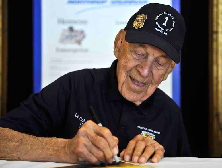 Lt. Col.  Richard E. Cole co-pilot of Gen. Jimmy Doolittle's B-25 plane #1, signs autographs during a meet and greet with the raiders for their 70th reunion, April 19 at the Hope Hotel, Fairborn, Ohio. At 96, Cole is the oldest of the remaining five Raiders and says the attention they receive still surprises him. (U.S. Air Force photo by Tech. Sgt. Bennie J. Davis III)
