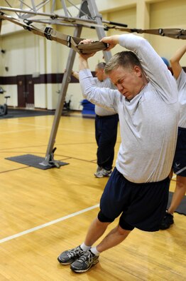U.S. Air Force Staff Sgt. Shawn Christensen performs a standing hip drop during a Total Body Resistance Exercise and Suspension Training course at the base fitness center on Seymour Johnson Air Force Base, N.C., April 19, 2012. TRX is dedicated toward military members to help them with durability and operational readiness. (U.S. Air Force photo/Staff Sgt. Courtney Richardson)