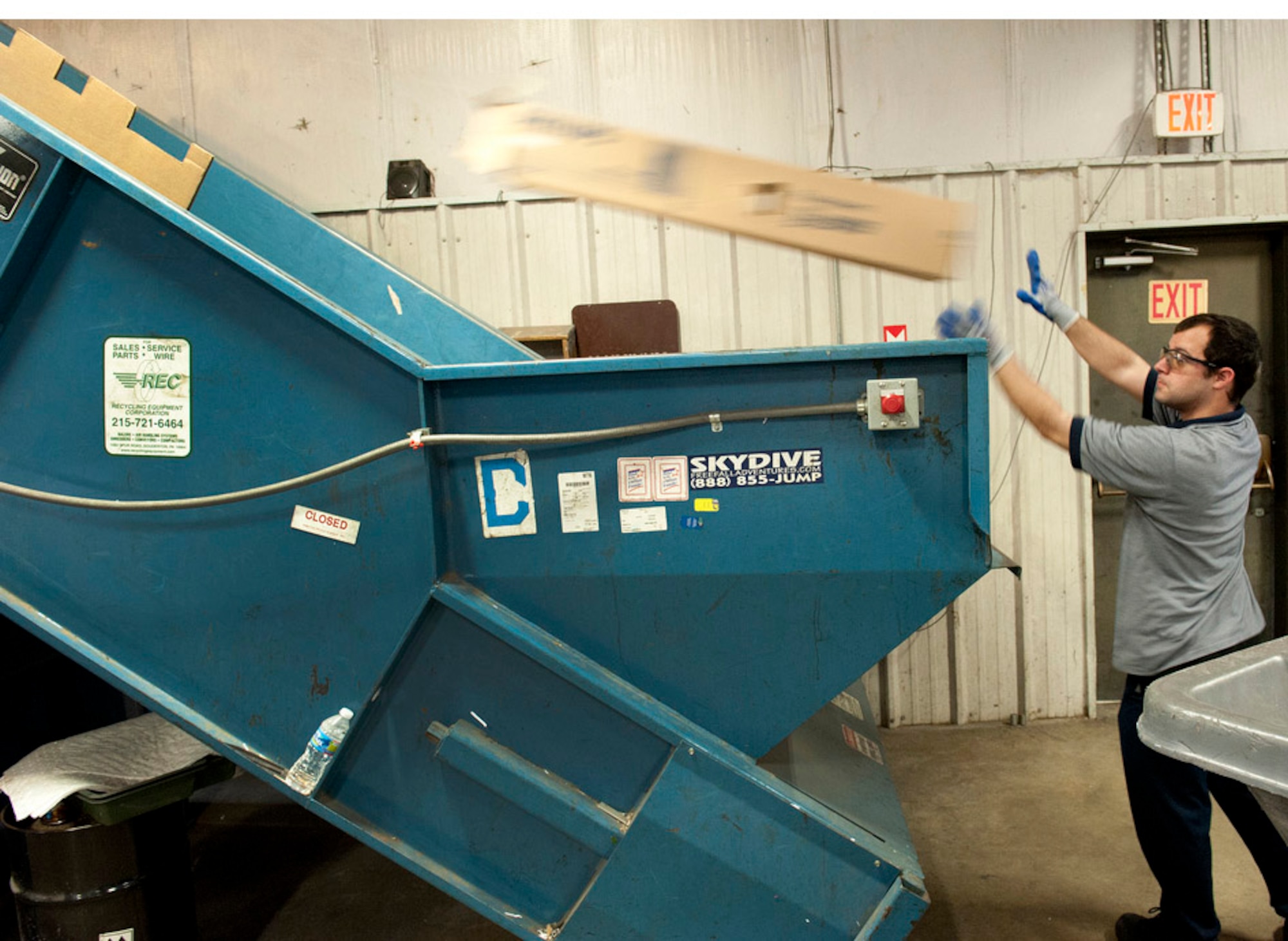 Timothy Carreras of the recycling center loads cardboard in the bailer here. The cardboard recycled at Joint Base-McGuire-Dix-Lakehurst prevented 327 tons of cardboard from ending up in landfills. (U.S. Air Force Photo by Russ Meseroll/Released)