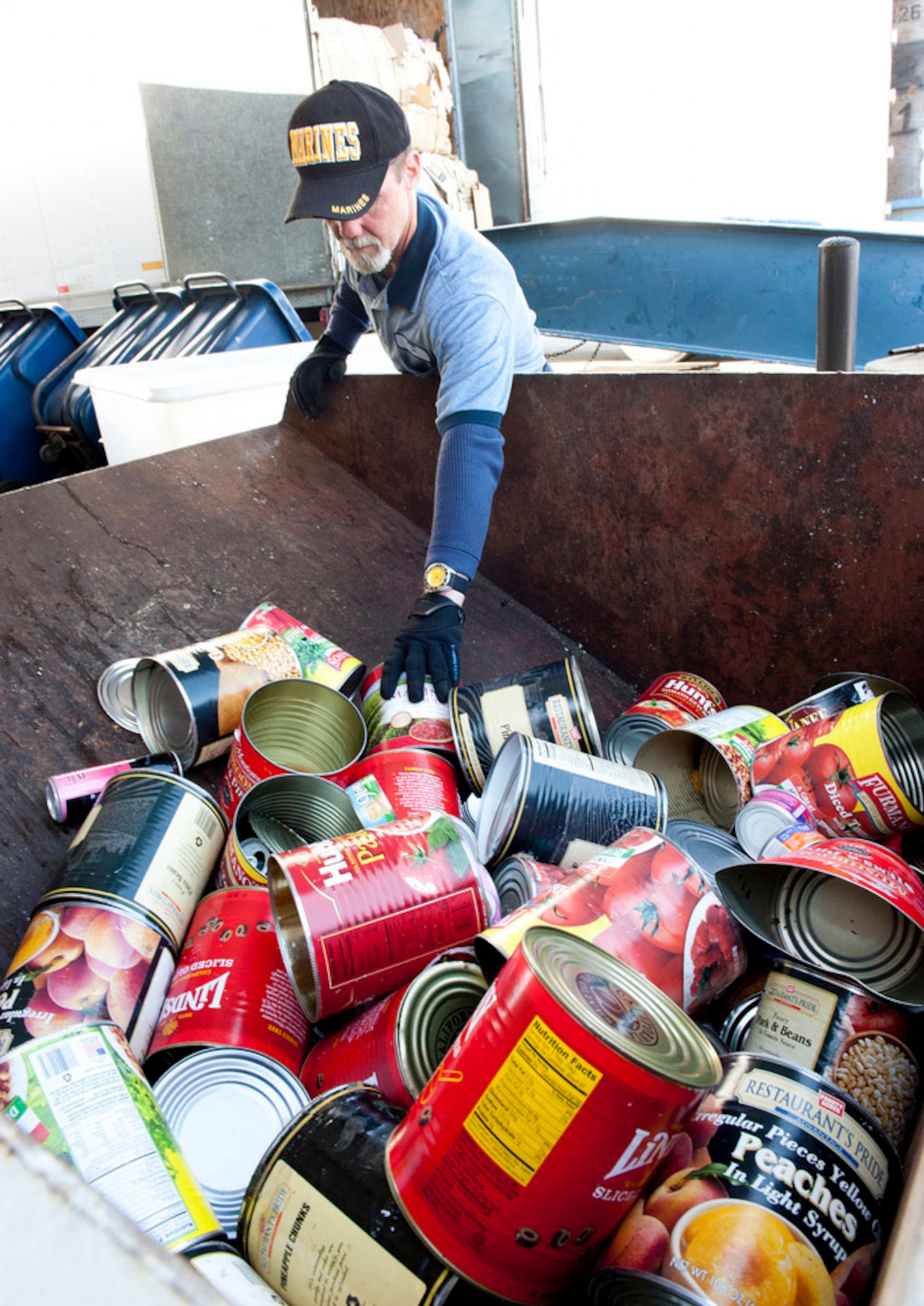 David McGee, of the Joint Base Recycling Center, readies the cans for recycling here. After the recycling process is complete the steel cans will command 10 cents per pound with the aluminum cans valued at 53 cents per pound.  The proceeds from the recycled items are returned to Joint Base McGuire-Dix-Lakehurst to defray the costs of the recycling program. Recycling helps reduce the need for landfills thus helping to preserve natural resources. (U.S. Air Force Photo by Russ Meseroll/Released)