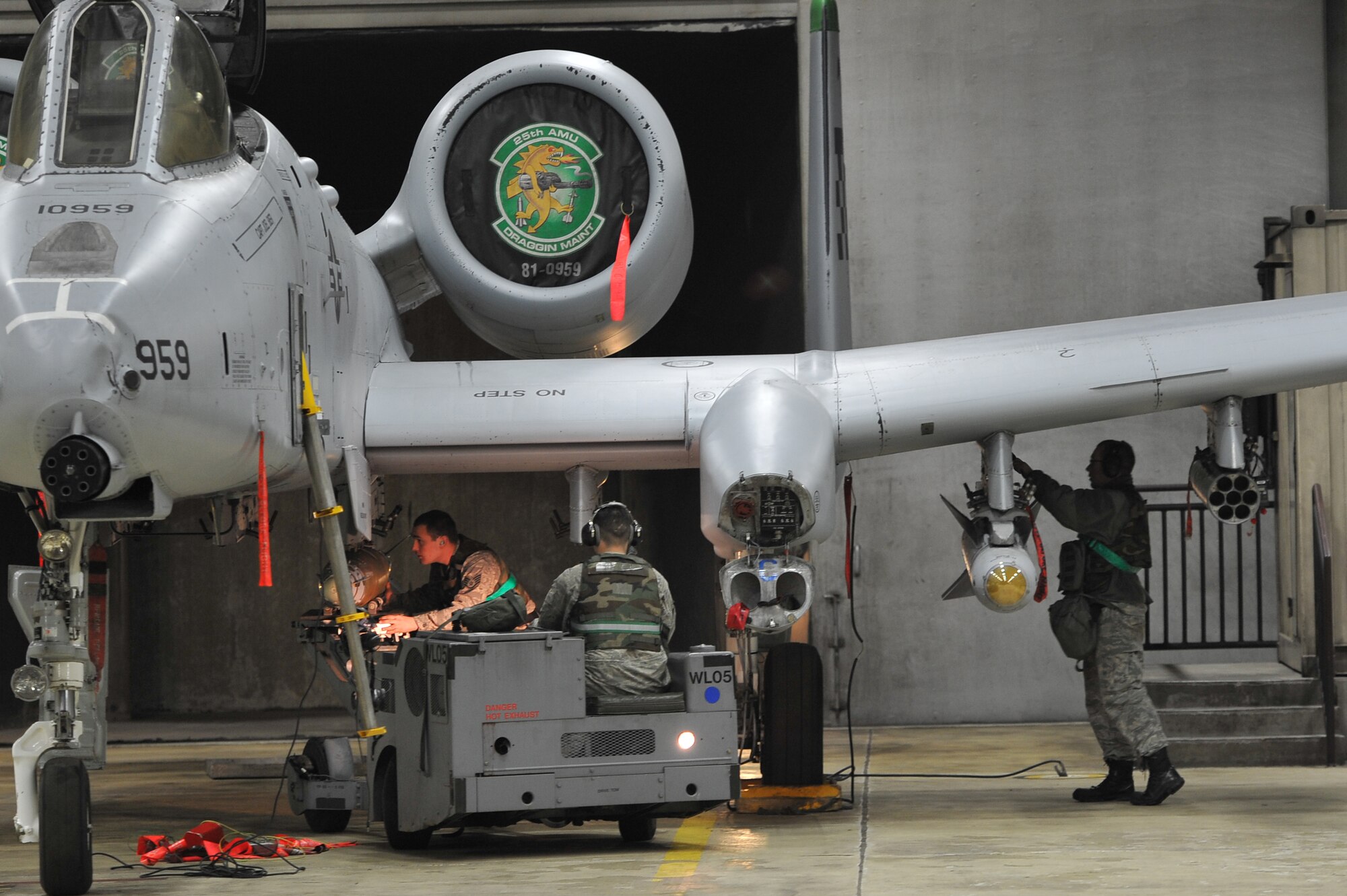 Members of the 25th Aircraft Maintenance Unit load munitions onto an A-10 Thunderbolt II during Beverly Midnight 12-02, an operational readiness exercise at Osan Air Base, Republic of Korea, April 23, 2012. BM 12-02 is the second half of Team Osan’s two-week consolidated unit inspection. (U.S. Air Force photo/Staff Sgt. Craig Cisek)