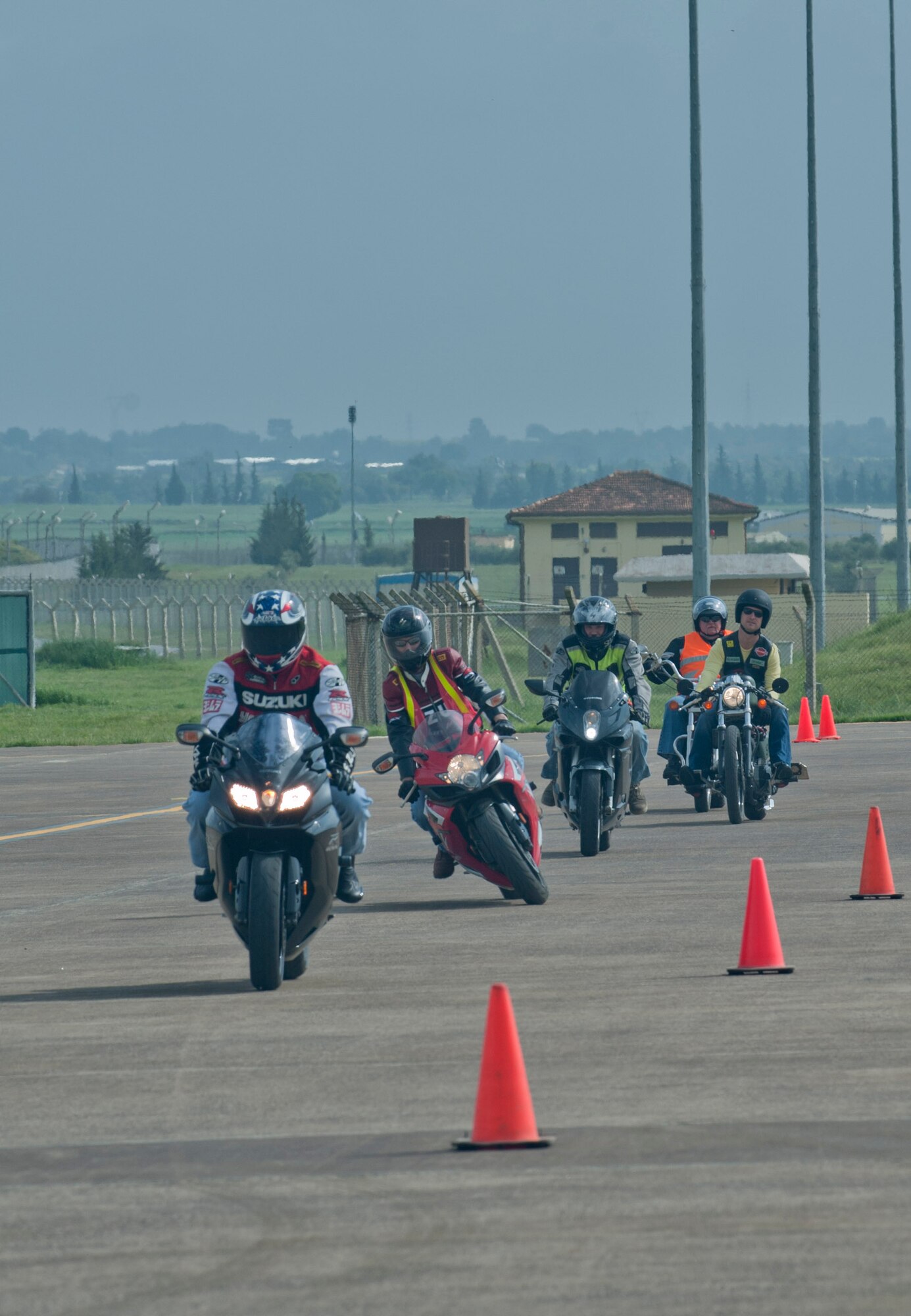 Members of Team Incirlik maneuver their motorcycles through a riding course during a Motorcycle Safety Rodeo April 20, 2012, at Incirlik Air Base, Turkey. The safety rodeo is required for all military motorcycle riders for on-and off-base driving. (U.S. Air Force photo by Senior Airman Anthony Sanchelli/Released)
