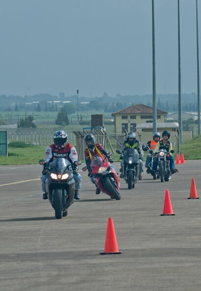 Members of Team Incirlik maneuver their motorcycles through a riding course during a Motorcycle Safety Rodeo April 20, 2012, at Incirlik Air Base, Turkey. The safety rodeo is required for all military motorcycle riders for on-and off-base driving. (U.S. Air Force photo by Senior Airman Anthony Sanchelli/Released)
