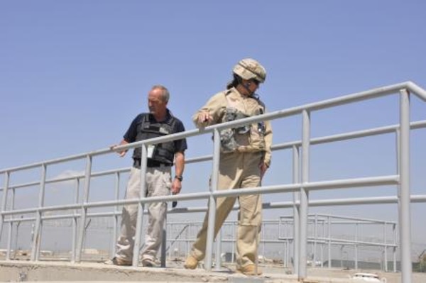 AFGHANISTAN — Penny Coulon, U.S. Army Corps of Engineers Afghanistan Engineer District-South quality assurance representative, and David Greenlief, ITT Exelis regional manager, inspect the new wastewater treatment facility aerators here, April 22, 2012.