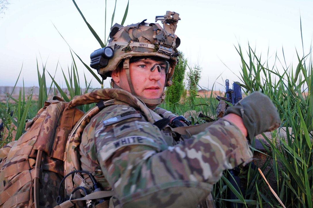 U.S. Army Sgt. Josh White signals soldiers behind him to forge ahead during a clearing mission as part of Operation Eagle Mountain in Didar, Afghanistan, April 13, 2012. White, a infantryman, is assigned to Company B, 5th Battalion, 20th Infantry Regiment. The operation's purpose was to clear the town of improvised explosive devices, and provide security to the town through U.S. and Afghan presence.