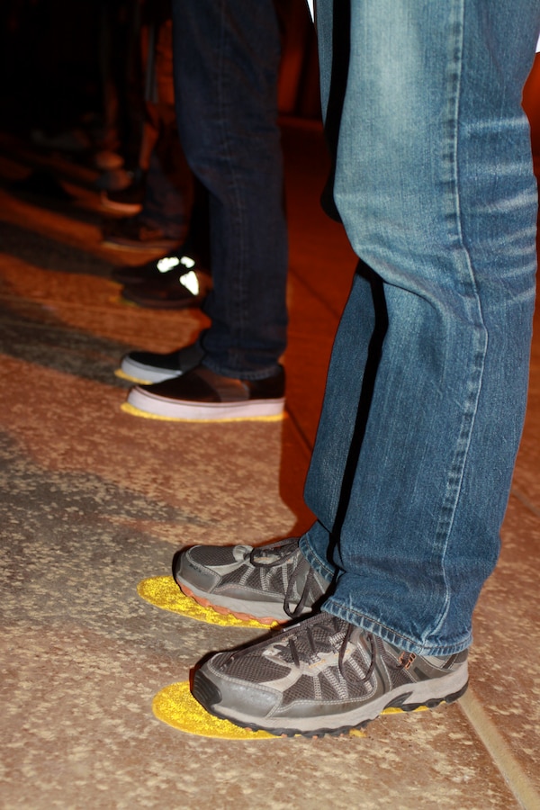 Recruits stand upon the yellow footprints outside of Receiving Company April 23 aboard Marine Corps Recruit Depot San Diego. The moment the recruits step foot on the depot, they stand on the yellow footprints where they receive a speech on how to stand at the position of attention.