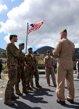 USS NEW YORK -- Maj. Dale R. Behm, right, detachment officer-in-charge of Marine Medium Tiltrotor Squadron 261 (reinforced), 24th Marine Expeditionary Unit, explains how Marine helicopter assets are used to aid Marine reconnaissance teams with members of the Gruppo Operativo Incursori, the Italian equivalent of U.S. Navy SEALs, here, during a port visit in La Spezia, Italy, April 23, 2012. The 24th MEU along with the Navy's Iwo Jima Amphibious Ready Group, is currently deployed as a theater reserve and crisis response force capable of a variety of missions from full-scale combat to humanitarian assistance and disaster relief. (Official USMC photo by Cpl. Michael Petersheim/Released)