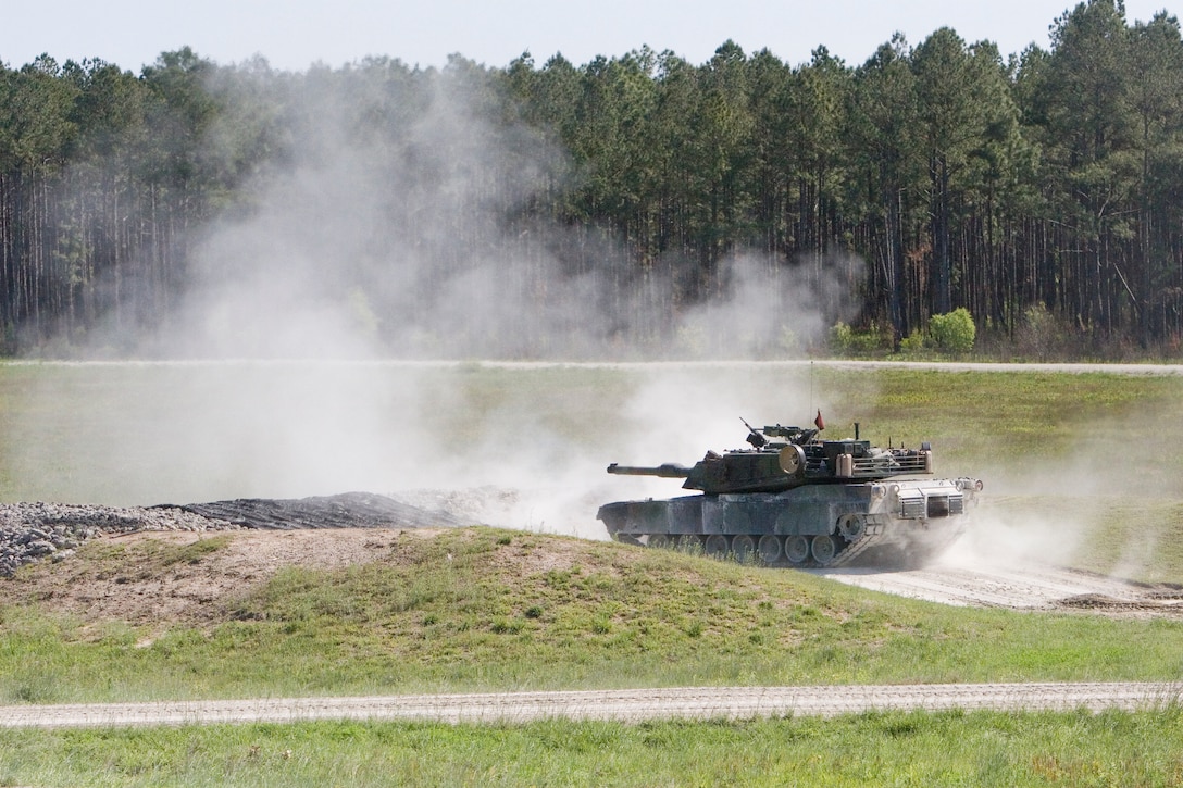Blue 4, the fourth M1A1 Abrams tank in 3rd Platoon, Company A, 2nd Tank Battalion, 2nd Marine Division, barely recoils as it fires its main gun at a target several hundred meters away during the company’s Gunnery Qualifications April 24.  The qualifications are a biannual, Marine Corps-wide event for the 1st and 2nd Tank Battalions.  The event tests the capabilities of individual tank crews as they run a course for time, proficiency and accuracy.  The crew that performs the best is formally recognized by its command and the team members are awarded the Navy and Marine Corps Achievement Medal.