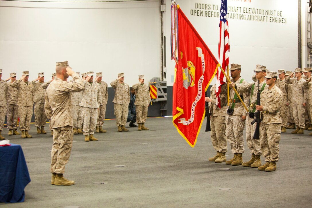 26th Marine Expeditionary Unit and Company C, 1st Battalion, 6th Marine Regiment, salute the 26th MEU color guard during a celebration of the 45th birthday of 26th MEU in the hanger bay of USS Wasp (LHD-1), April 24, 2012. 26th MEU was activated in 1967, and since then, has successfully completed various operations and exercises spanning across the globe. In a dynamic and ever changing world, the 26th MEU has always been a certain force in an uncertain world. (U.S. Marine Corps photo by Cpl. Christopher Q. Stone/Released)