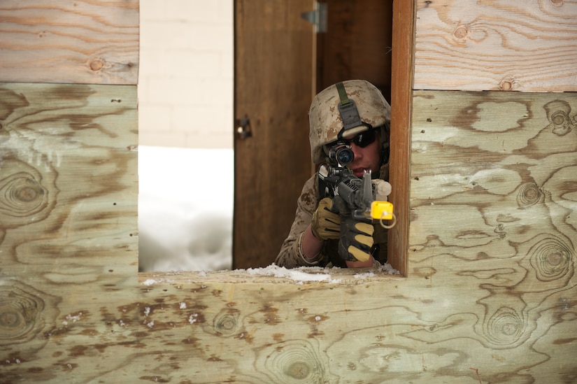 JOINT BASE ELMENDORF-RICHARDSON, Alaska -- Lance Cpl. Cooper Curtis, D Company, Anti-Terrorism Battalion, takes aim April 21 during training in urban operations at JBER's Baumeister City MOUT Complex. (U.S. Air Force photo/David Bedard)