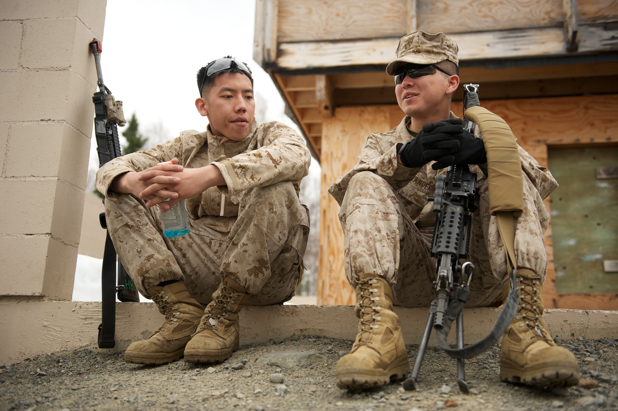 JOINT BASE ELMENDORF-RICHARDSON, Alaska -- D Company, Anti-Terrorism Battalion Marines Lance Cpl. Steven Lee of Sacramento, Calif., and Lance Cpl. Matthew Alexander of Anchorage, take a break April 21 during training in urban operations at JBER's Baumeister City MOUT Complex. (U.S. Air Force photo/David Bedard)