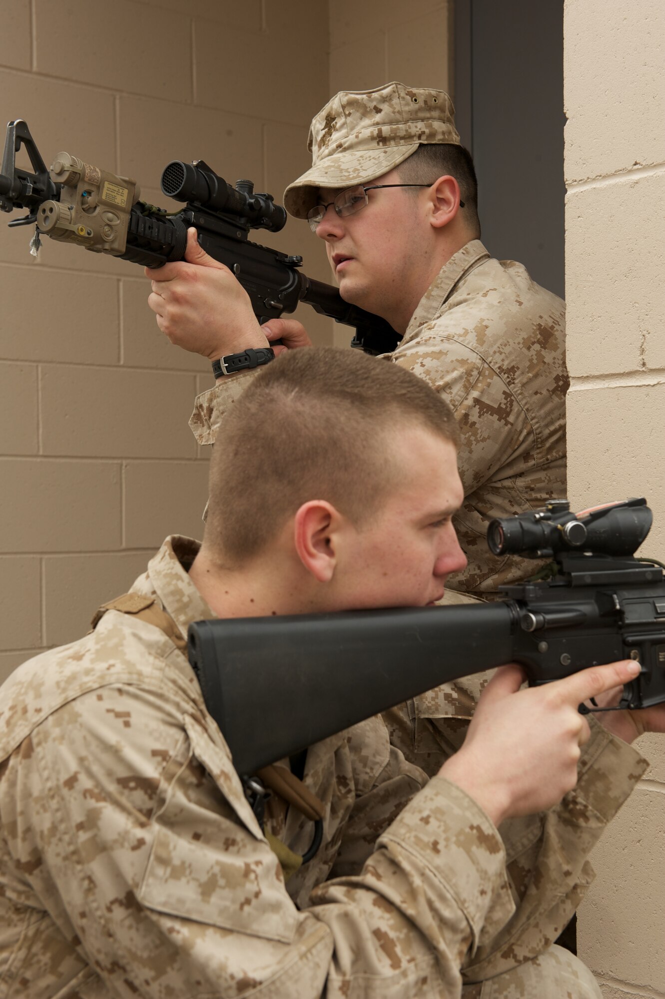 JOINT BASE ELMENDORF-RICHARDSON, Alaska -- D Company, Anti-Terrorism Battalion Marines Lance Cpl. Grant Badgerroberts of Palmer and Pfc. Jeff Melvin of Soldotna, provide security April 21 during training in urban operations at JBER's Baumeister City MOUT Complex. (U.S. Air Force photo/David Bedard)