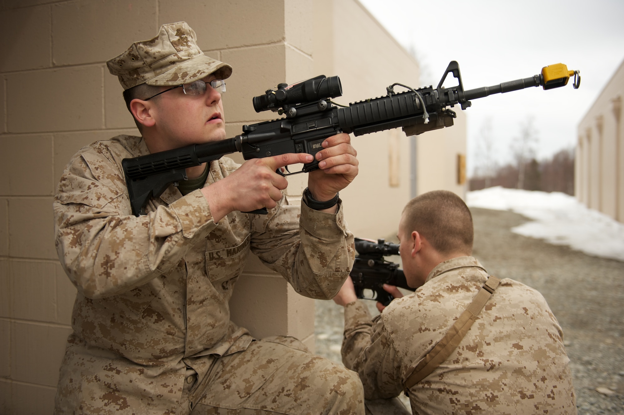JOINT BASE ELMENDORF-RICHARDSON, Alaska -- D Company, Anti-Terrorism Battalion Marines Lance Cpl. Grant Badgerroberts of Palmer and Pfc. Jeff Melvin of Soldotna, provide security April 21 during training in urban operations at JBER's Baumeister City MOUT Complex. (U.S. Air Force photo/David Bedard)