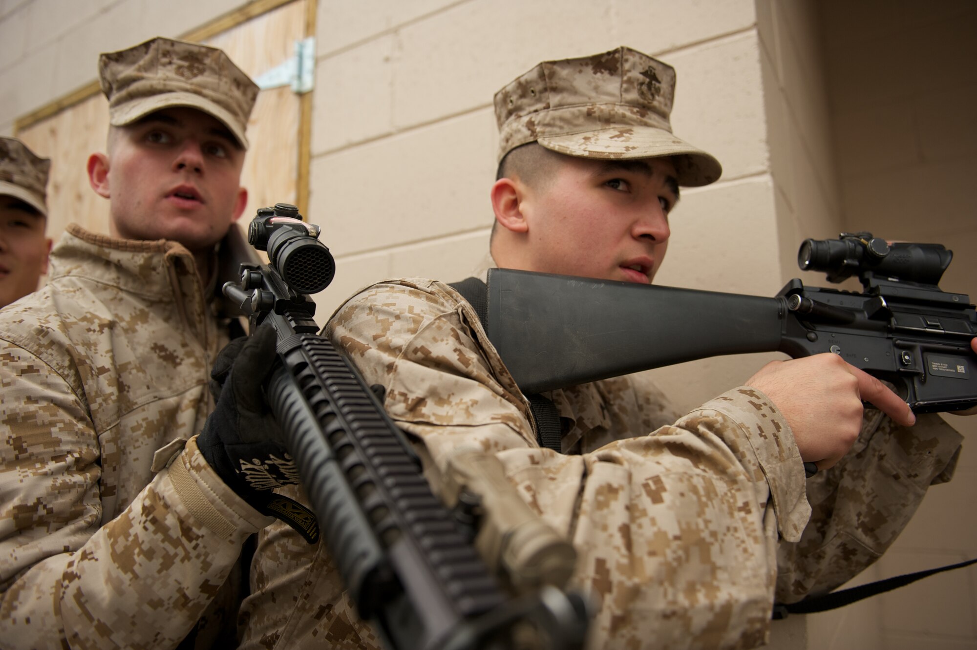 JOINT BASE ELMENDORF-RICHARDSON, Alaska -- D Company, Anti-Terrorism Battalion Marines Pfc. Joel Cage of Eagle River and Pfc. Kevin Corey of Anchorage, wait for the command to enter a building April 21 during training in urban operations at JBER's Baumeister City MOUT Complex. (U.S. Air Force photo/David Bedard)