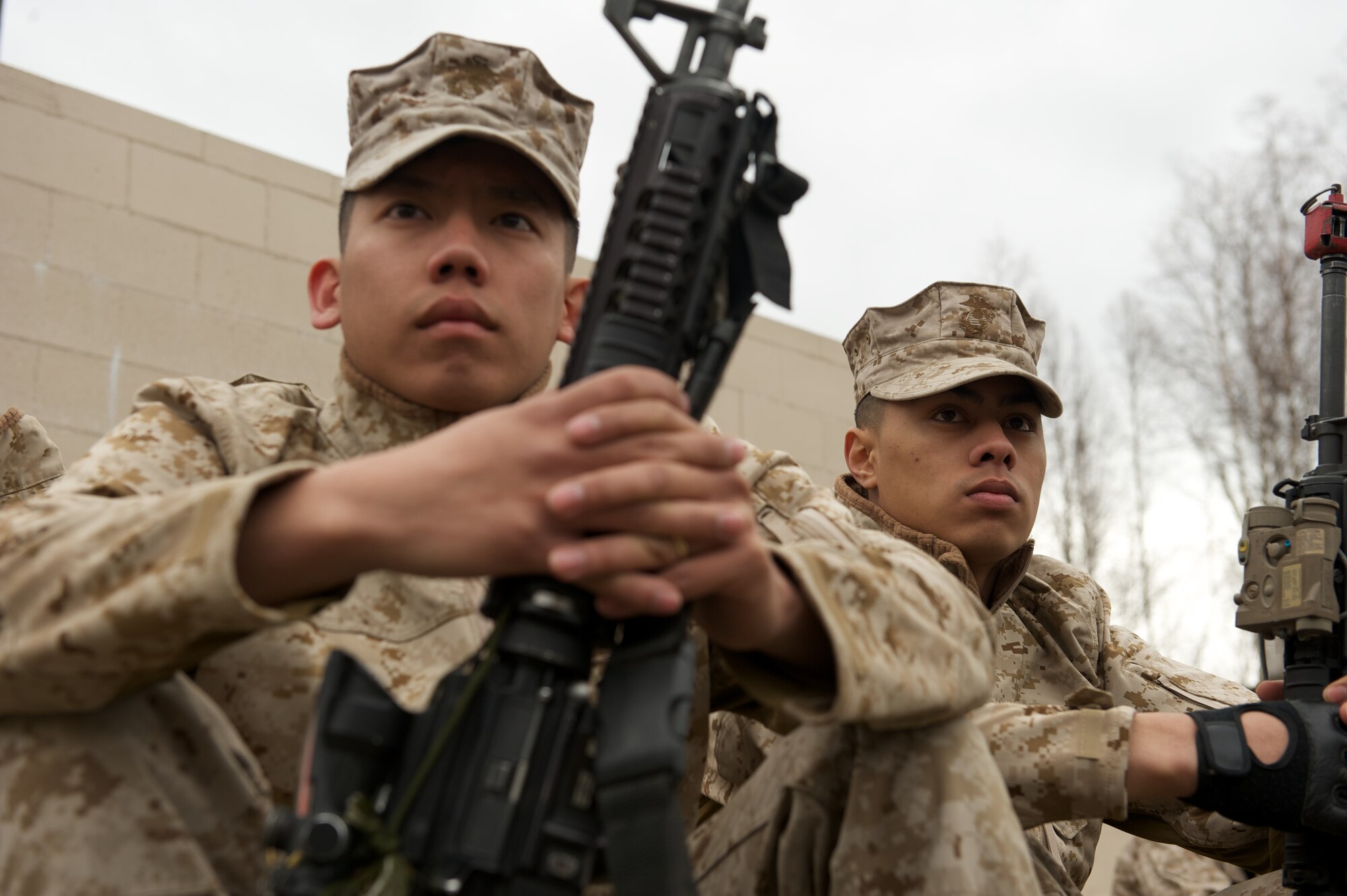 JOINT BASE ELMENDORF-RICHARDSON, Alaska -- D Company, Anti-Terrorism Battalion Marines Lance Cpl. Steven Lee of Sacramento, Calif., and Lance Cpl. Deion Delara of Anchorage, listen to instructions April 21 before training in urban operations at JBER's Baumeister City MOUT Complex. (U.S. Air Force photo/David Bedard)