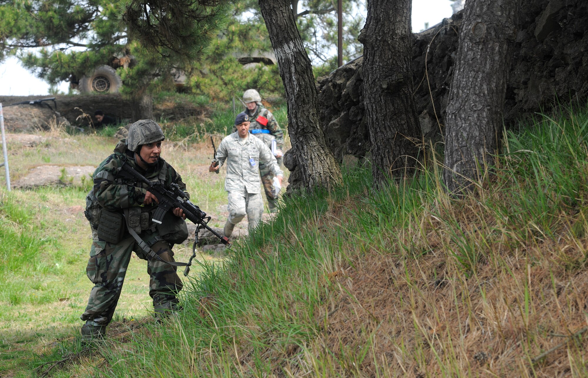 Tech. Sgt. Venessa Brown, 8th Security Forces Squadron member, responds to gunshots fired during a mock firefight between 8th SFS Defenders and opposing forces in the BEVERLY MIDNIGHT 12-02 peninsula-wide operational readiness exercise at Kunsan Air Base, Republic of Korea, April 24, 2012. The 8th SFS members eliminated all of the opposing forces except for capturing one prisoner of war with minimal injuries of their own. (U.S. Air Force photo/Staff Sgt. Rasheen A. Douglas)