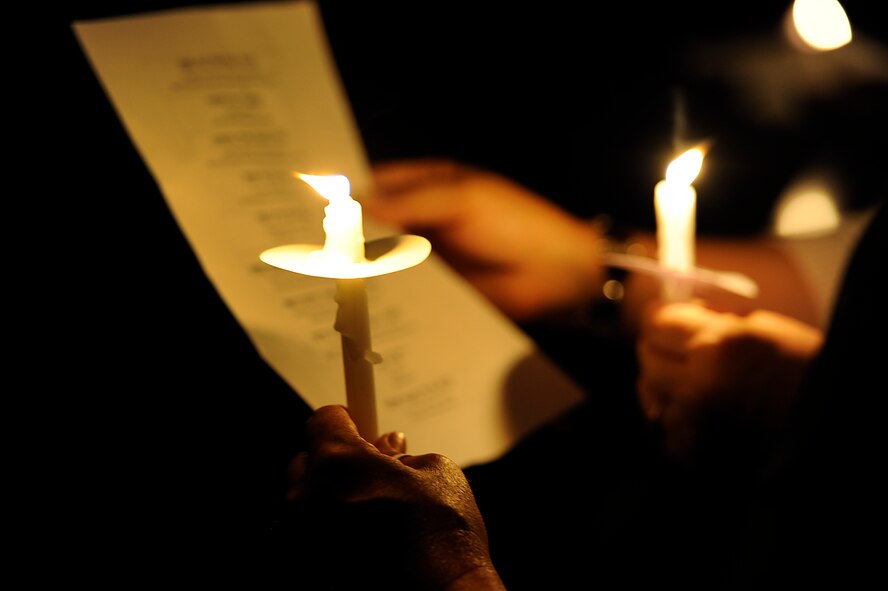 Monica McCain, wife of U.S. Air Force Chaplain (Col.) Steven McCain, 18th Wing chaplain, and Sheila Sellers, wife of Chaplain (Maj.) Randy Sellers, 18th Wing senior protestant chaplain, read a Hebrew prayer by candlelight during the Holocaust Memorial observance candlelight vigil at Chapel 1 on Kadena Air Base, Japan, April 19, 2012. During the ceremony, hundreds of people who attended joined in remembrance of the millions who died during the Holocaust. (U.S. Air Force photo by Airman 1st Class Maeson L. Elleman/Released)