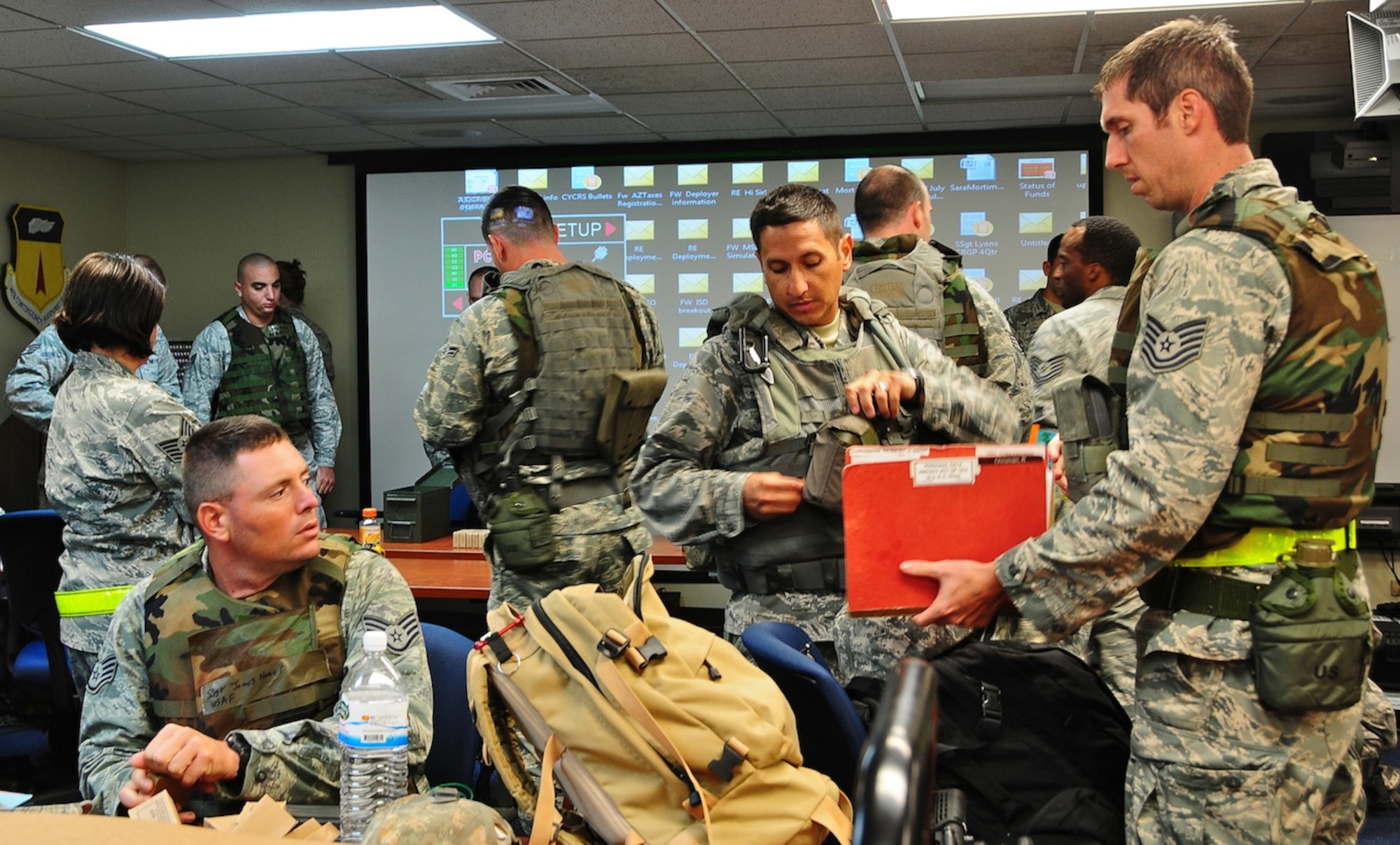 The 644th Combat Communications Squadron members prepare their deployment paper work, their weapons and their gear before heading off to simulated Forward Operating Base Dragon hill April 19. The 644 CBCS is conducting a deployment exercise from April 16 to 27 in order to test their capabilities in a deployed environment and improve their war-fighting capabilities.  (U.S. Air Force photo by Airman 1st Class Marianique Santos)