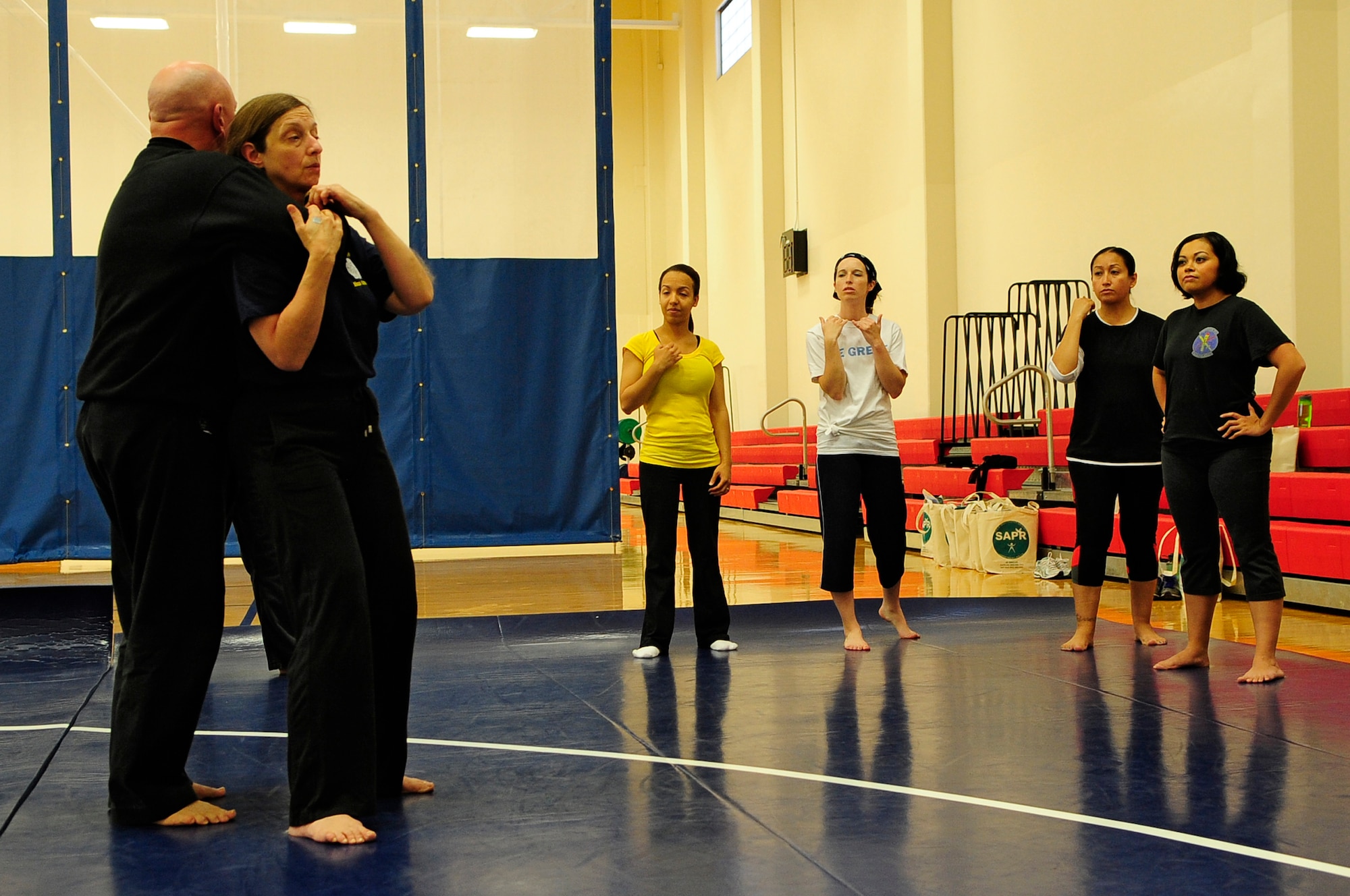 VANDENBERG AIR FORCE BASE, Calif. -- Mike Myers and Valerie Pallani, Jiu-Jitsu instructors, demonstrate an escape technique during a self-defense class at the Fitness Center here Friday, April 20, 2012. The class was sponsored by the 30th Space Wing Sexual Assault Prevention and Response office in conjunction with Sexual Assault Awareness Month. (U.S. Air Force photo/Michael Peterson)