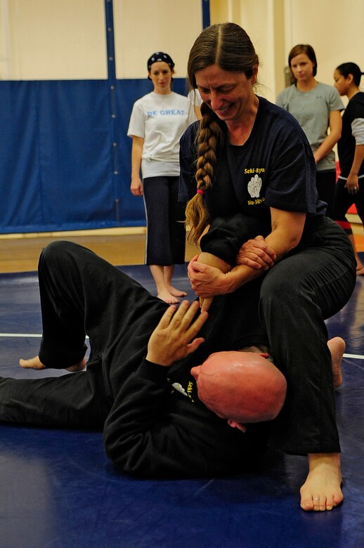 VANDENBERG AIR FORCE BASE, Calif. -- Valerie Pallani, a Jiu-Jitsu instructor, demonstrates grappling skills during a self-defense class at the fitness center here Friday, April 20, 2012. The class was sponsored by the 30th Space Wing Sexual Assault Prevention and Response office in conjunction with Sexual Assault Awareness Month. (U.S. Air Force photo/Michael Peterson)