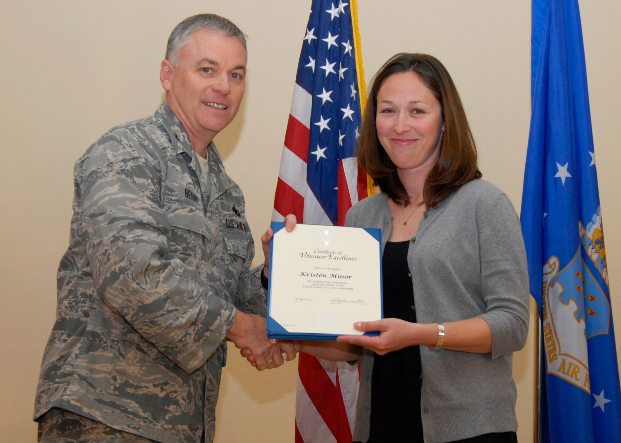 Kristen Minor received the 2011 Volunteer Excellence Award April 18, during a ceremony honoring the contributions of Team Edwards volunteers. After receiving the award, presented by Col. Buddy Berry, 95th Mission Support Group commander, Edwards leadership congratulated Minor for her outstanding achievement and thanked her for her volunteer efforts. (Air Force Photo by Laura Mowry)