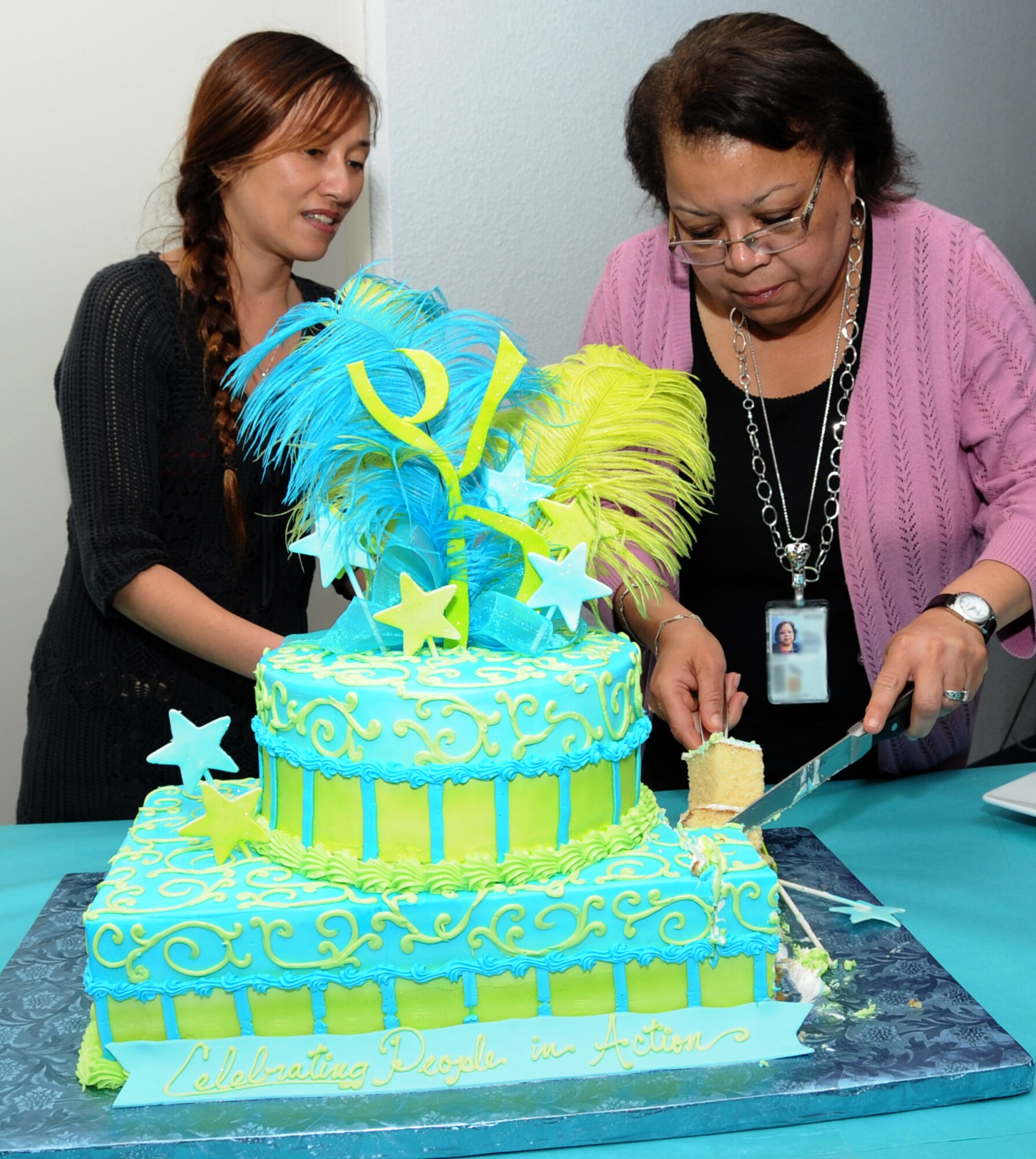 Liah Wadleigh, Keesler volunteer, and Linda Edison, 81st Force Support Squadron, cut a cake during the Keesler Volunteer Recognition Ceremony April 17, 2012, at the Sablich Center, Keesler Air Force Base, Miss.  Many individual and group awards were presented including volunteer excellence nominees and award winners, volunteer of the quarter nominees and squadron key spouses.  (U.S. Air Force photo by Kemberly Groue)