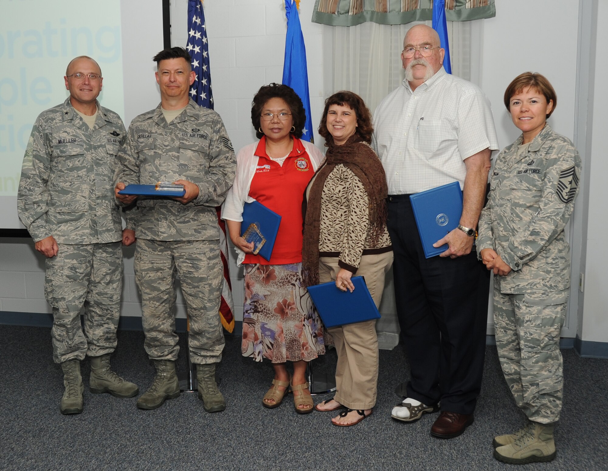 Brig. Gen. Andrew Mueller, 81st Training Wing commander; Tech. Sgt. Publio Casilla, 335th Training Squadron;  Linda Worth, spouse of Lt. Col. Brian Worth, 336th TRS commander; Elly McAlpine, spouse of Lt. Col. Bradley McAlpine, 335th TRS; Larry Tabor, 81st TRW; and Chief Master Sgt. Angelica Johnson, 81st TRW command chief, take a photo at the Keesler Volunteer Recognition Ceremony April 17, 2012, at the Sablich Center, Keesler Air Force Base, Miss.  Casilla, who accepted the award on behalf of his wife, Terry, Worth, McAlpine, and Tabor, were all winners of the Keesler Volunteer Excellence award.  (U.S. Air Force photo by Kemberly Groue)