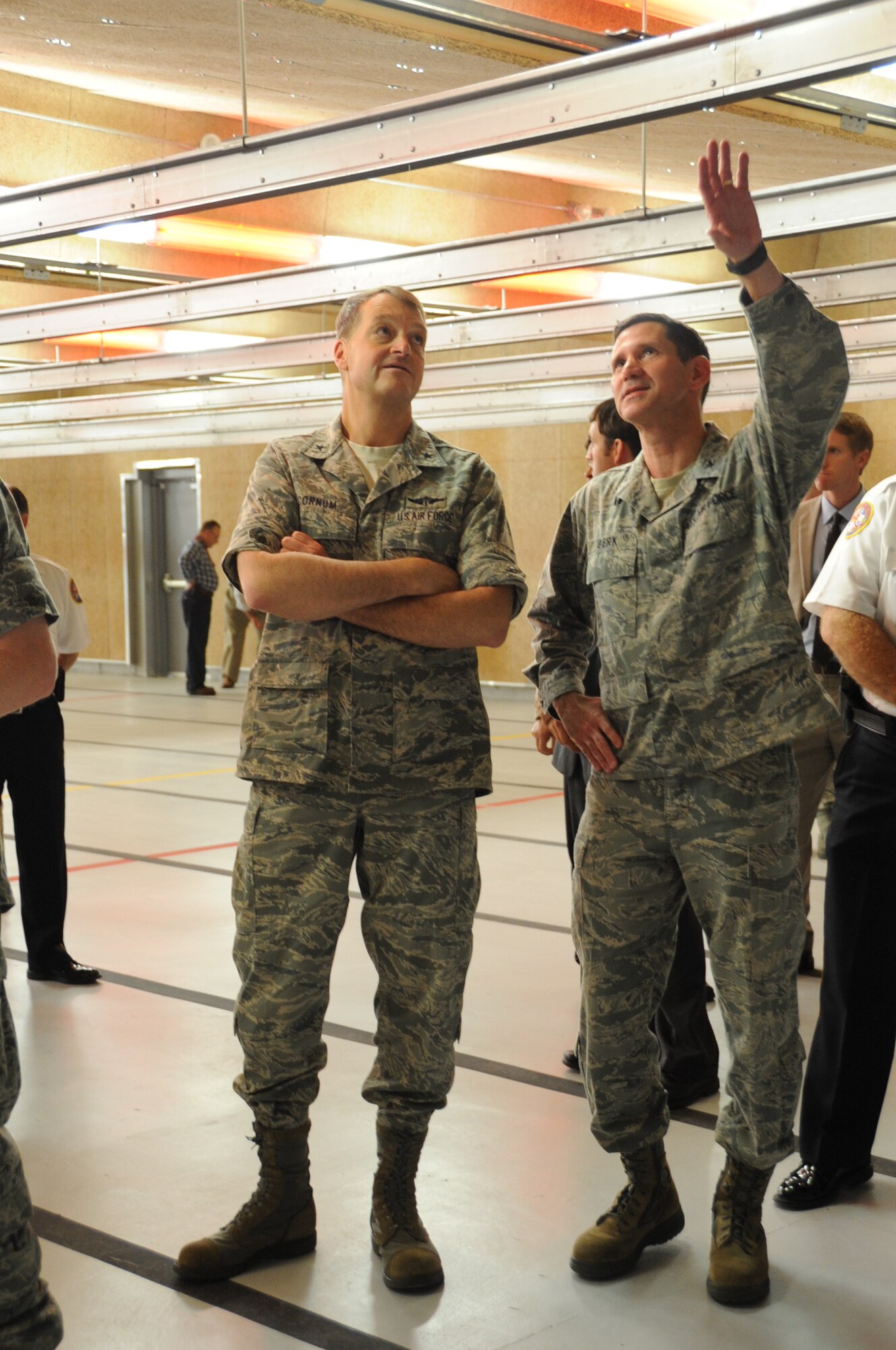 Brig. Gen. Kory Cornum, 81st Medical Group commander, and Col. Rodney Berk, 81st Mission Support Group commander, discuss the details of the new 81st Security Forces Squadron Firing Range following a ribbon cutting ceremony April 20, 2012,at Keesler Air Force Base, Miss.  The small arms firing range is a $5.3 million project that will provide weapons training and qualification to 81st Security Forces Squadron members and those who need weapons qualification for deployments. Previously, to meet this requirement, Keesler members had to travel 17 miles to the Navy's combat arms training and maintenance facility at Camp Keller, Miss.  Construction began in November 2011 and the safety test was completed March 28.  (U.S. Air Force photo by Kemberly Groue)