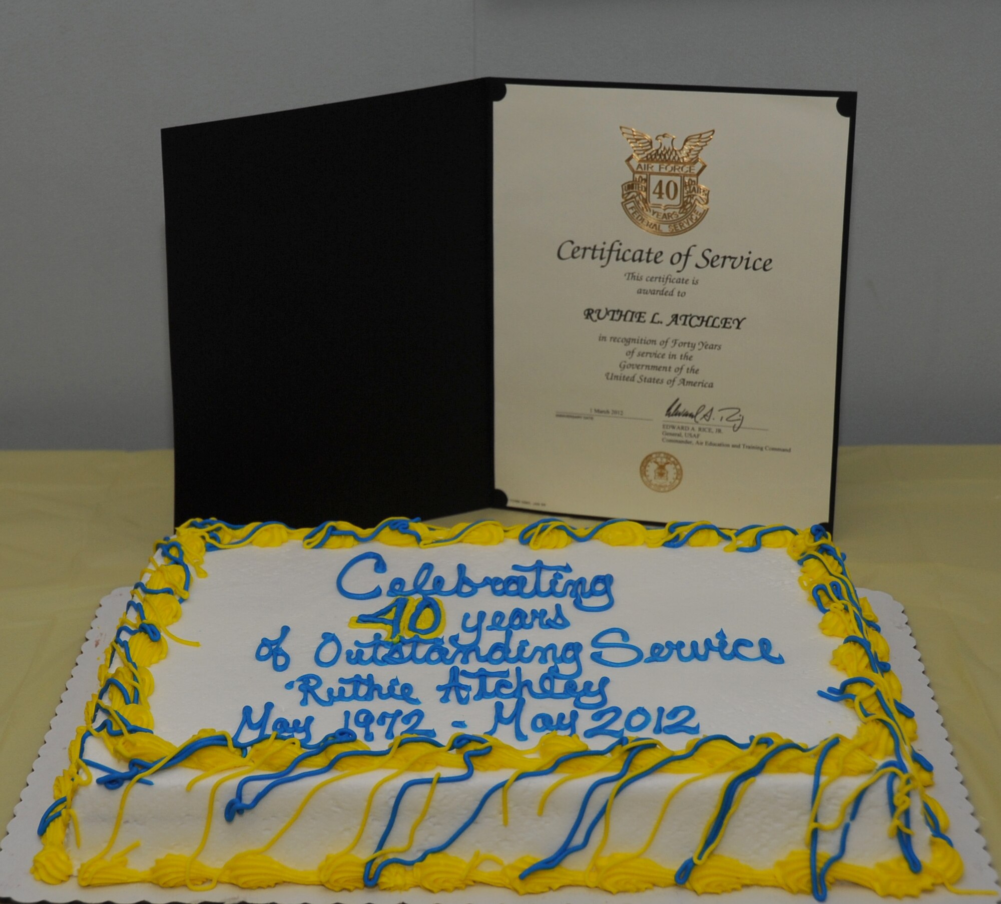 A Certificate of Service certificate and a cake were presented during a ceremony celebrating the 40 years of service that Ruthie Atchley, 81st Communications Squadron chief of base records management, has committed to the Air Force as a Department of Defense civil service member sits on display during a ceremony April 17, 2012, at the 81st CS building, Keesler Air Force Base, Miss.  (U.S. Air Force photo by Kemberly Groue)