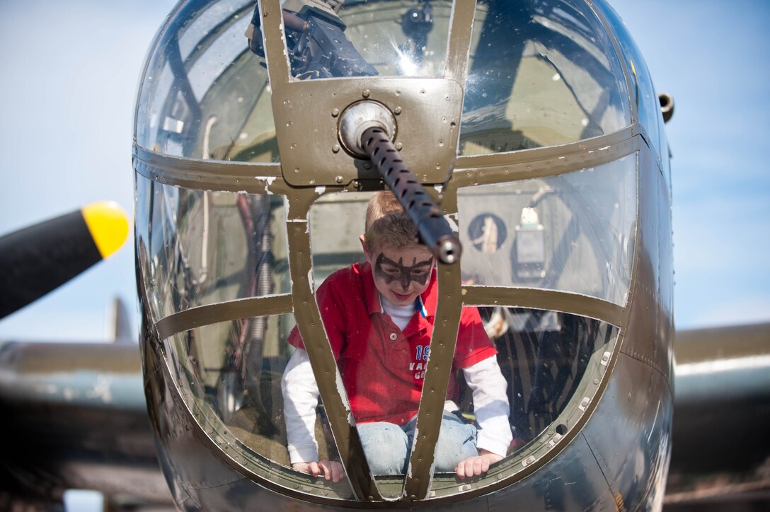 Michael Bunker, son of 1st Lt. Anthony Bunker, 34th Bomb Squadron weapon systems officer, climbs inside of “Grumpy” a B-25D Mitchell Bomber from the Historic Flight Foundation at Ellsworth Air Force Base, S.D., April 20, 2012. Ellsworth hosted “Grumpy” as a static display for Airmen and citizens of Rapid City, S.D., during its return journey for the 70th anniversary of the Doolittle Raid. (U.S. Air Force photo by Airman 1st Class Zachary Hada/Released)