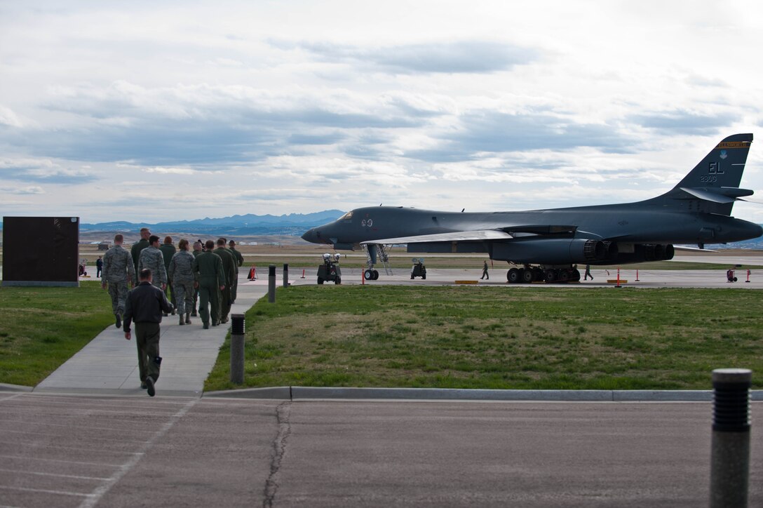 Airmen assemble at the flightline to await the arrival of the Historic Flight Foundation’s B-25D Mitchell Bomber “Grumpy” in conjunction with the 70th anniversary of the famous Doolittle Raid at Ellsworth Air Force Base, S.D., April 20, 2012. The B-25 flew the same route used by the Army Air Corps to deliver aircraft during World War II for its return journey to Snohomish County Airport north of Seattle, Wash. (U.S. Air Force photo by Airman 1st Class Zachary Hada/Released)
