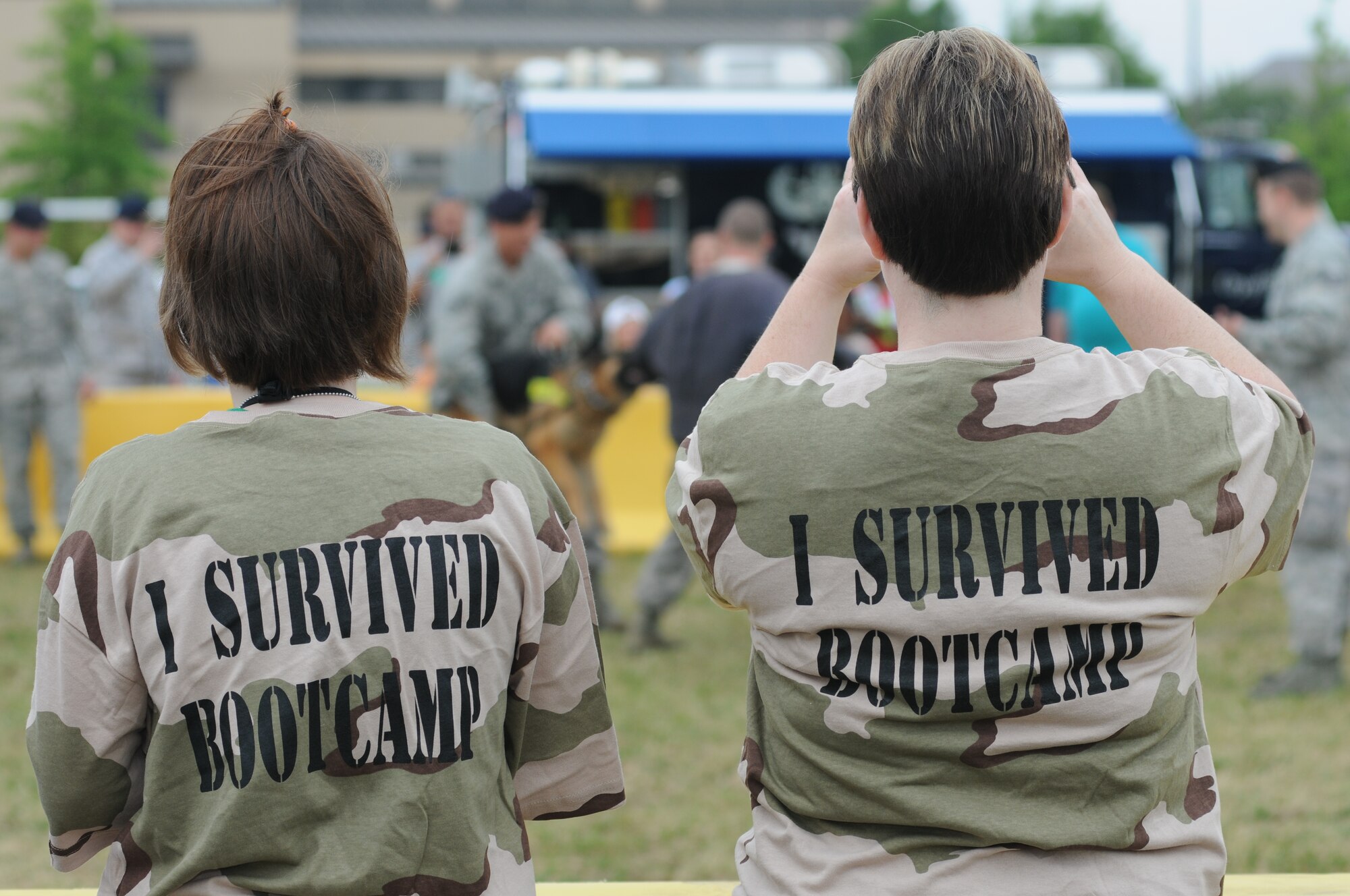 Samantha, 13, and her mom, Dana Rutledge, dependants of Master Sgt. Michael Rutledge, 333rd Training Squadron, watch the 81st Security Forces Squadron military working dog demonstration during Operation Hero April 21, 2012, at Keesler Air Force Base, Miss.  Operation Hero takes place twice a year.  The event was designed to help children better understand what a deployment is and what happens when their parents deploy. (U.S. Air Force photo by Kemberly Groue)