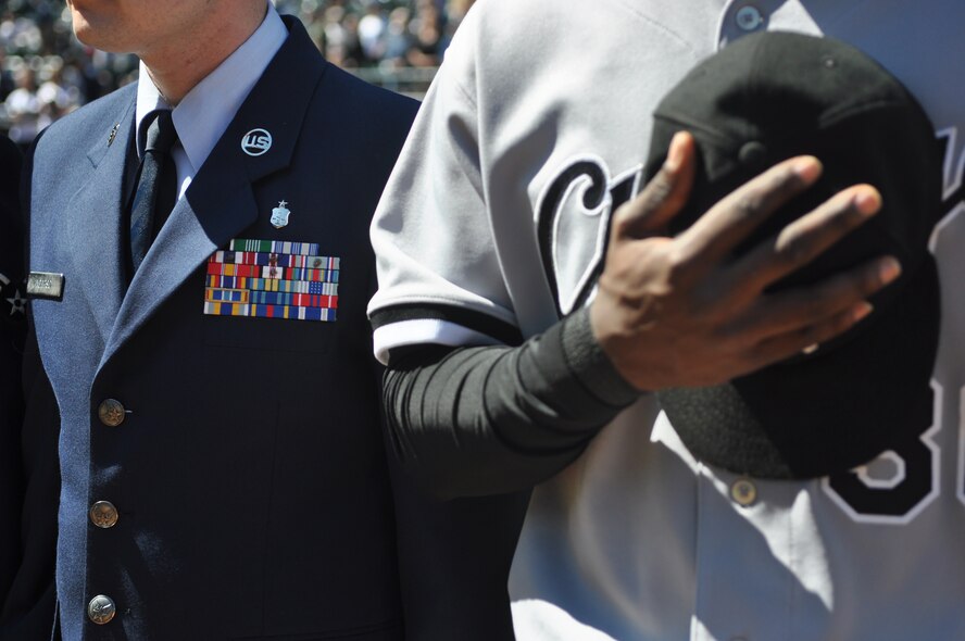 Staff Sgt. Alan Anderson, 62nd Medical Squadron, stands beside a Chicago White Sox player during opening ceremonies at the 11th annual Seattle Mariners Armed Forces Day April 21, 2012, at Safeco Field in Seattle, Wash. (U.S. Air Force photo/Senior Airman Leah Young)