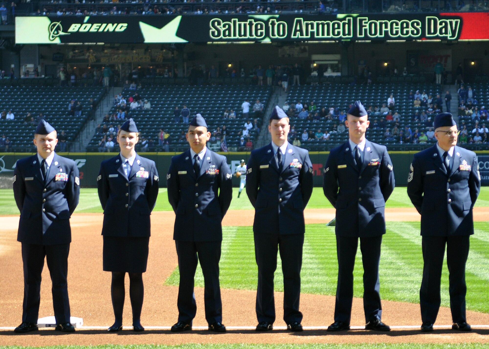 62nd Airlift Wing Airmen and other military representatives stand on the third base line during opening ceremonies at the 11th annual Seattle Mariners Armed Forces Day April 21, 2012, at Safeco Field in Seattle, Wash. The team paid tribute to the men and women serving in the military. (U.S. Air Force photo/Senior Airman Leah Young)