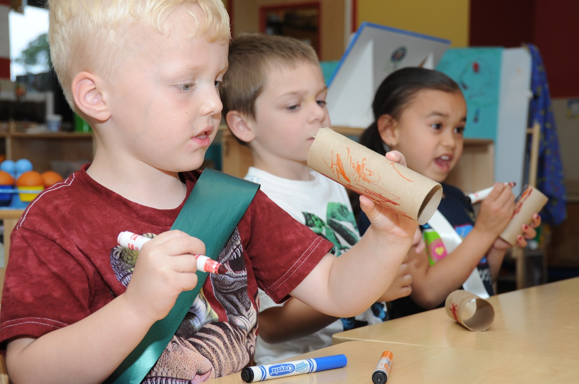 Five-year-olds Trenton Peters, Joseph Lenkowski and Braelyanna Rawaekklang decorate their kazoos during a Keesler 4-H Cloverbuds meeting April 17, 2012, at the Child Development Center, Keesler Air Force Base, Miss.  The Keesler 4-H Cloverbuds program is an interactive curriculum-based program designed for 5-6 year olds.  The group meets twice a month while attending the CDC.  Trenton is the son of Maj. Laurie Peters, 81st Medical Group.  Joseph is the son of Master Sgt. Joseph Lenkowski III, 403rd Maintenance Squadron.  Braelyanna is the daughter of Staff Sgt. Naronksuk Rawaekklang, 81st Diagnostic and Therapeutics Squadron. (U.S. Air Force photo by Kemberly Groue)