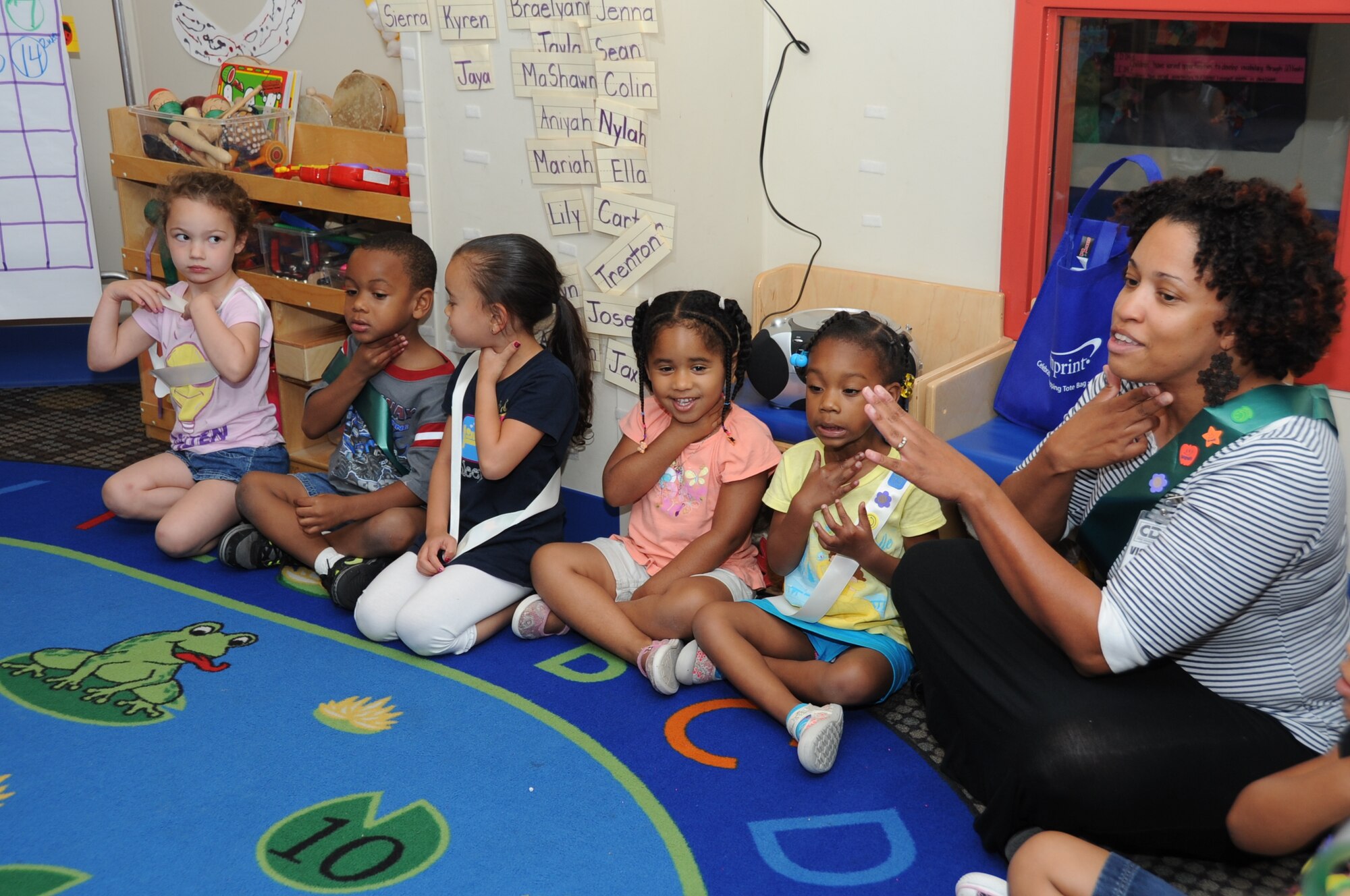 Kim Gowdy, 4-H representative, teaches the Keesler 4-H Cloverbuds how to feel vibrations on your throat as you make noises in preparation for the day’s activity which is making hand-made kazoos April 17, 2012, at the Child Development Center, Keesler Air Force Base, Miss.  The Keesler 4-H Cloverbuds program is an interactive curriculum-based program designed for 5-6 year olds.  The group meets twice a month while attending the CDC.  (U.S. Air Force photo by Kemberly Groue)