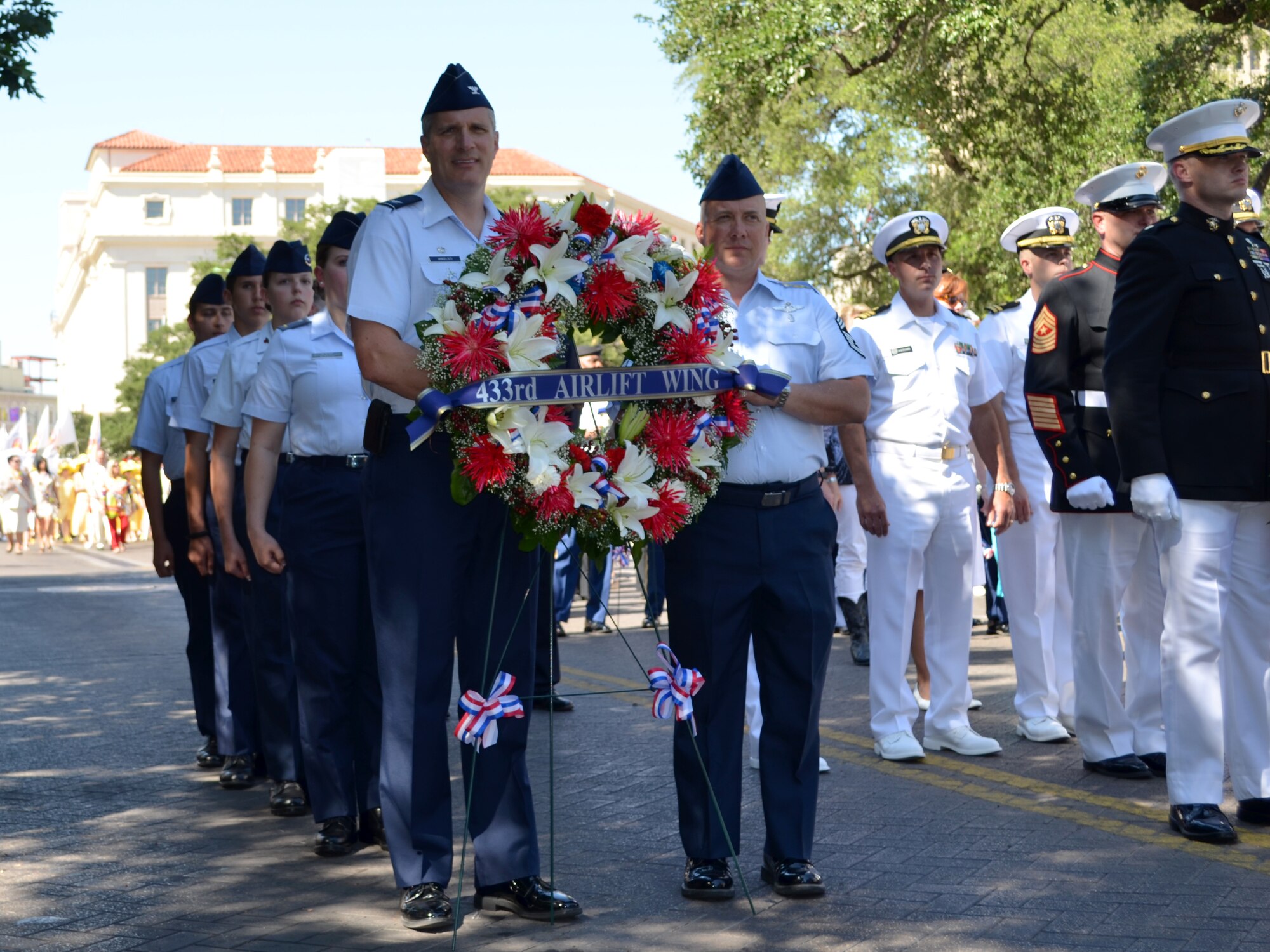 Col. Aaron Vangelisti, 433rd Airlift Wing Vice Commander carries a wreath alongside Chief Master Sgt. Rodney Christa, 433rd Medical Group, during the annual Fiesta Pilgrimage to the Alamo ceremony April 23, 2012 in San Antonio, Texas.. (U.S. Air Force photo/ Maj. Tim Wade)