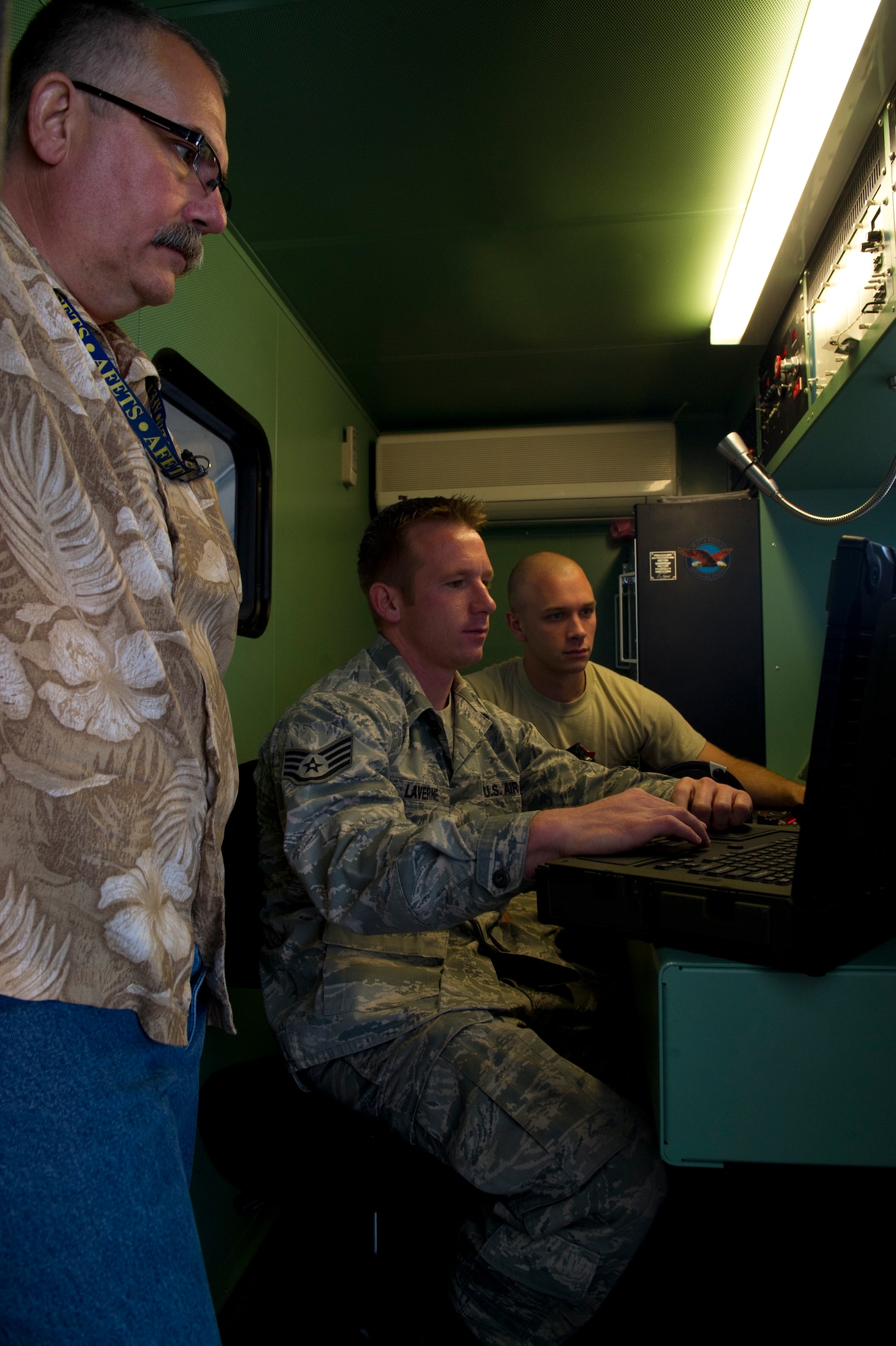 HOLLOMAN AIR FORCE BASE, N.M. – Byron Brancio, a contractor with 49th Aircraft Maintenance Squadron; Staff Sgt. Travis Laverne, 49th Maintenance Squadron test cell technician; and Staff Sgt. Michael Welch, 49th MXS propulsion and flight technician, sit in a M37 test stand of a run cab April 19. The run cab allows for the safe portable control of an engine test. (U.S. Air Force photo by Airman 1st Class Michael A. Shoemaker/Released)