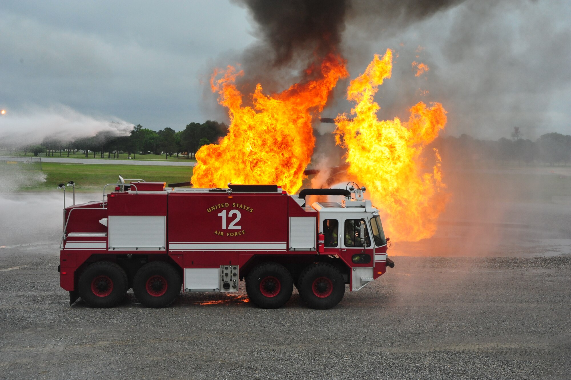 Maxwell Fire Department firefighters spray a simulated burning aircraft during a training scenario on April 19. The fire department trains regularly to increase readiness and stay proficient in their craft. (Air Force photo by Airman 1st Class William Blankenship)