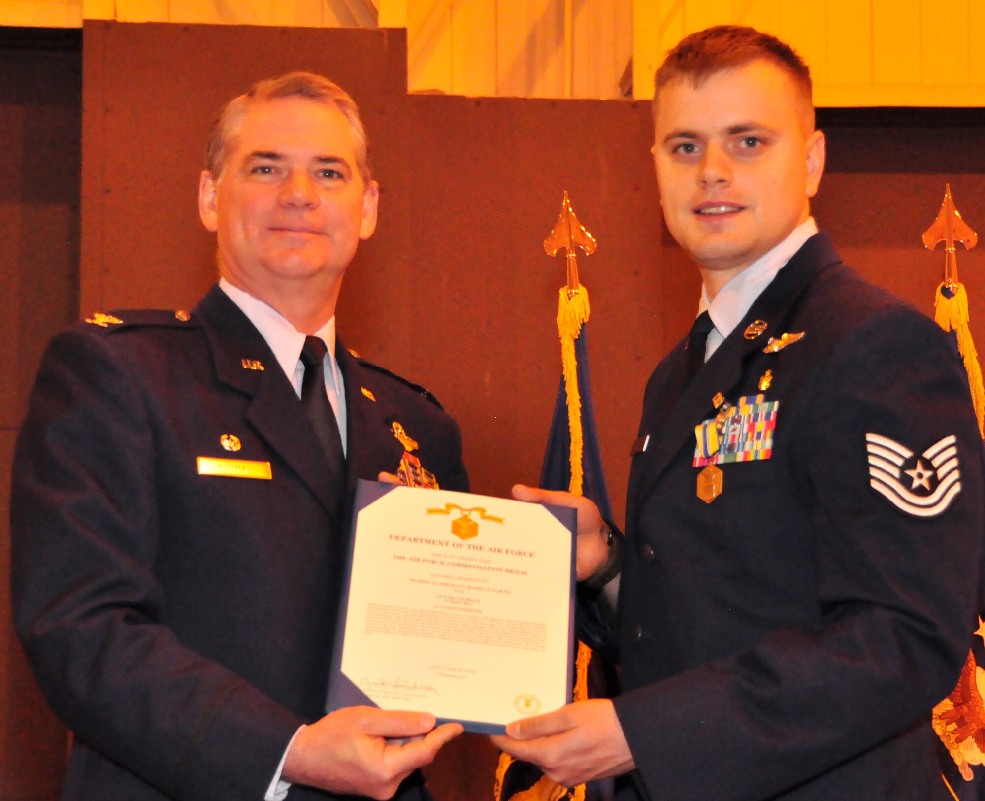 302nd Airlift Wing commander’s call has little bit of everything.  Air Force Reserve Tech. Sgt. Daniel Curtis an aeromedical technician with the 34th Aeromedical Squadron (right) receives the Air Force Commendation Medal from Col. Jay Pittman, Jr., 302nd AW commander, April 15 at Peterson Air Force Base, Colo. Sergeant Curtis was awarded the medal for life-saving actions he took when assisting a passenger onboard an international flight from Europe to the United States during his return home from deployment.(U.S. Air Force photo/Staff Sgt. Stephen J. Collier)