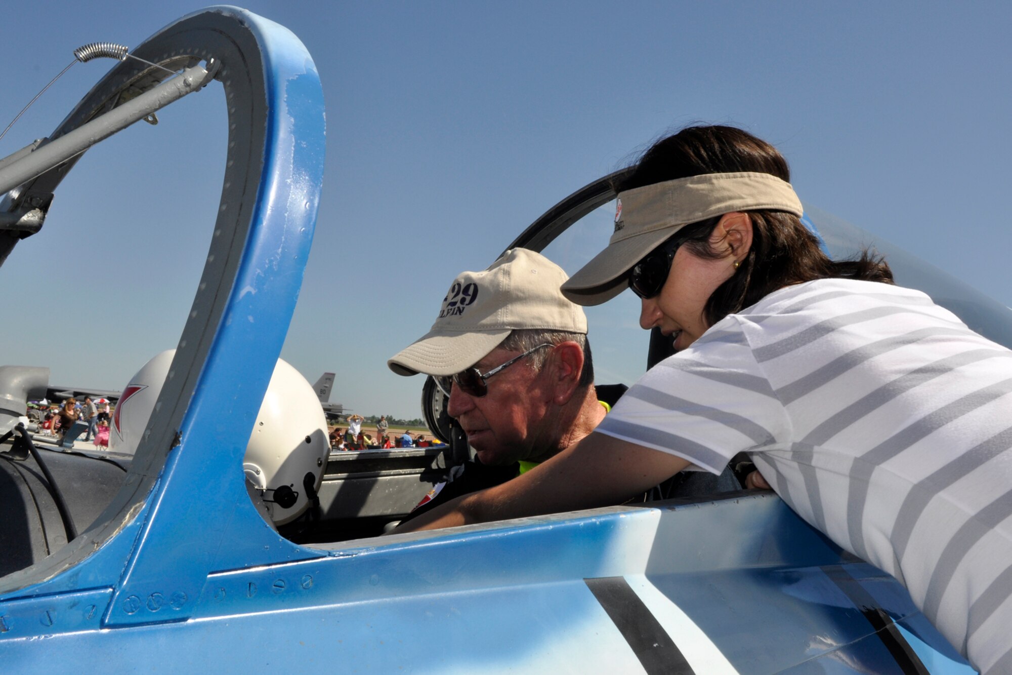 U.S. Navy Reserve retired CDR. Mike Akin receives a little help from Eva Klimentova confirming the translation of the labeling on the panels in his Russian/Czech L-29 Delphin jet aircraft at the 2012 Defenders of Liberty Air Show at Barksdale Air Force Base, La., April 22, 2012. Klimentova, who is a citizen of the Czech Republic visiting the United States, offered to help Alkin who has owned the jet for only a year and a half. The Delfin is 45 years old and Akin has been flying 44 years. (U.S. Air Force photo by Master Sgt. Jeff Walston)