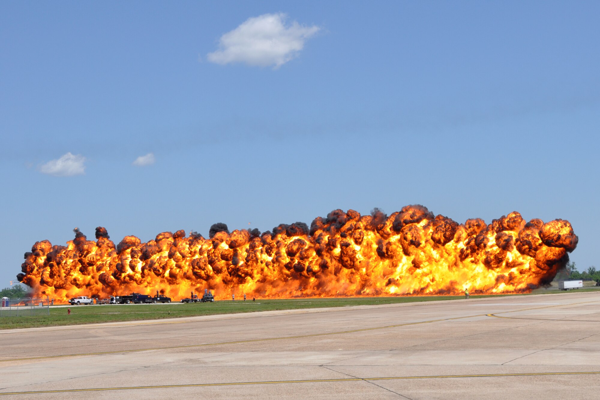 A wall of fire simulates the results of a bombing run by a B-52 Stratofortress during the 2012 Defenders of Liberty Air Show at Barksdale Air Force Base, La., April 22, 2012. Both the 307th Bomb Wing and 917th Fighter Group provided static displays for the air show. (Courtesy photo by Eva Klimentova)